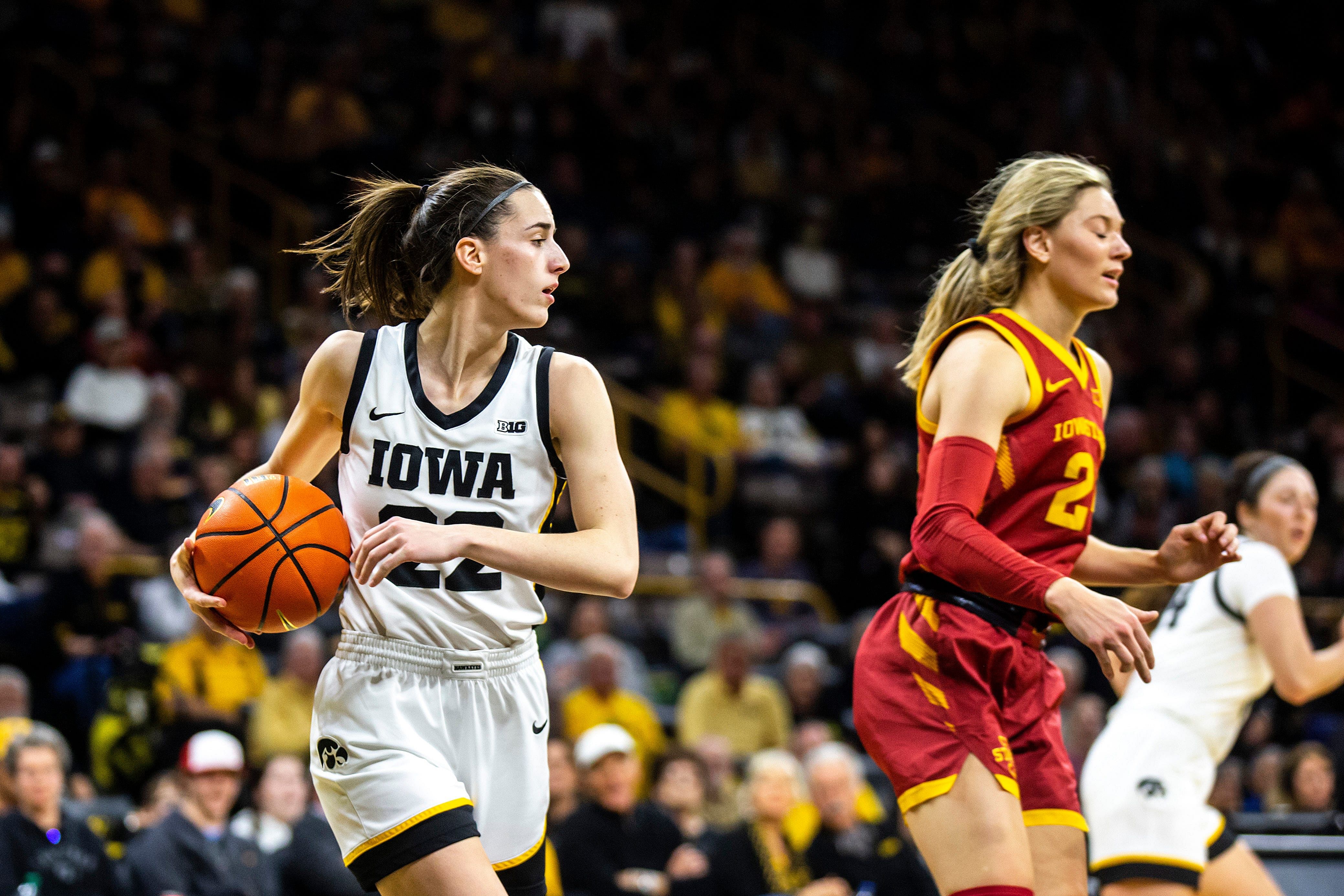 Iowa guard Caitlin Clark (22) pulls down a rebound against Iowa State