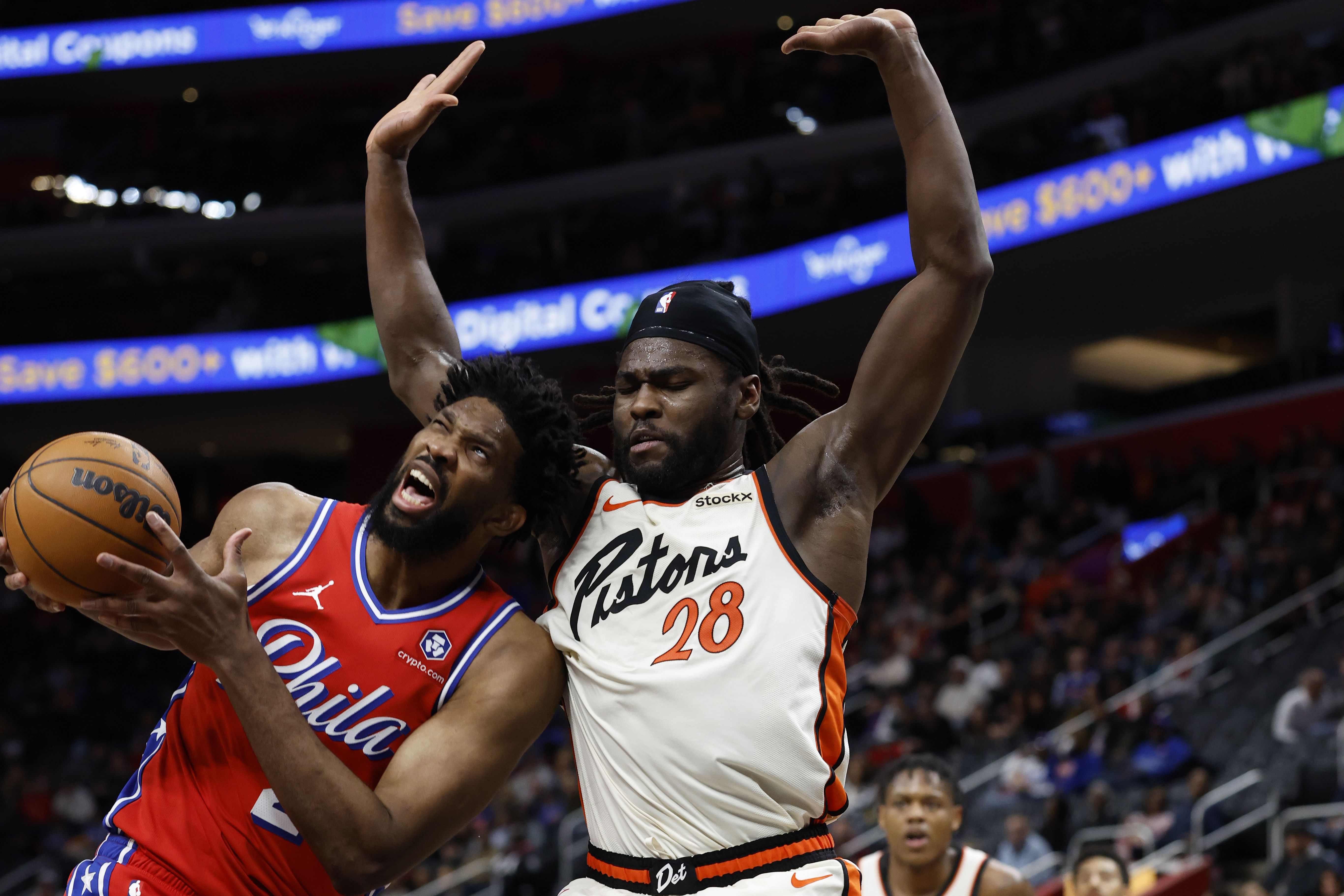 Feb 7, 2025; Detroit, Michigan, USA; Philadelphia 76ers center Joel Embiid (21) is defended by Detroit Pistons center Isaiah Stewart (28) in the first half at Little Caesars Arena. Mandatory Credit: Rick Osentoski-Imagn Images - Source: Imagn