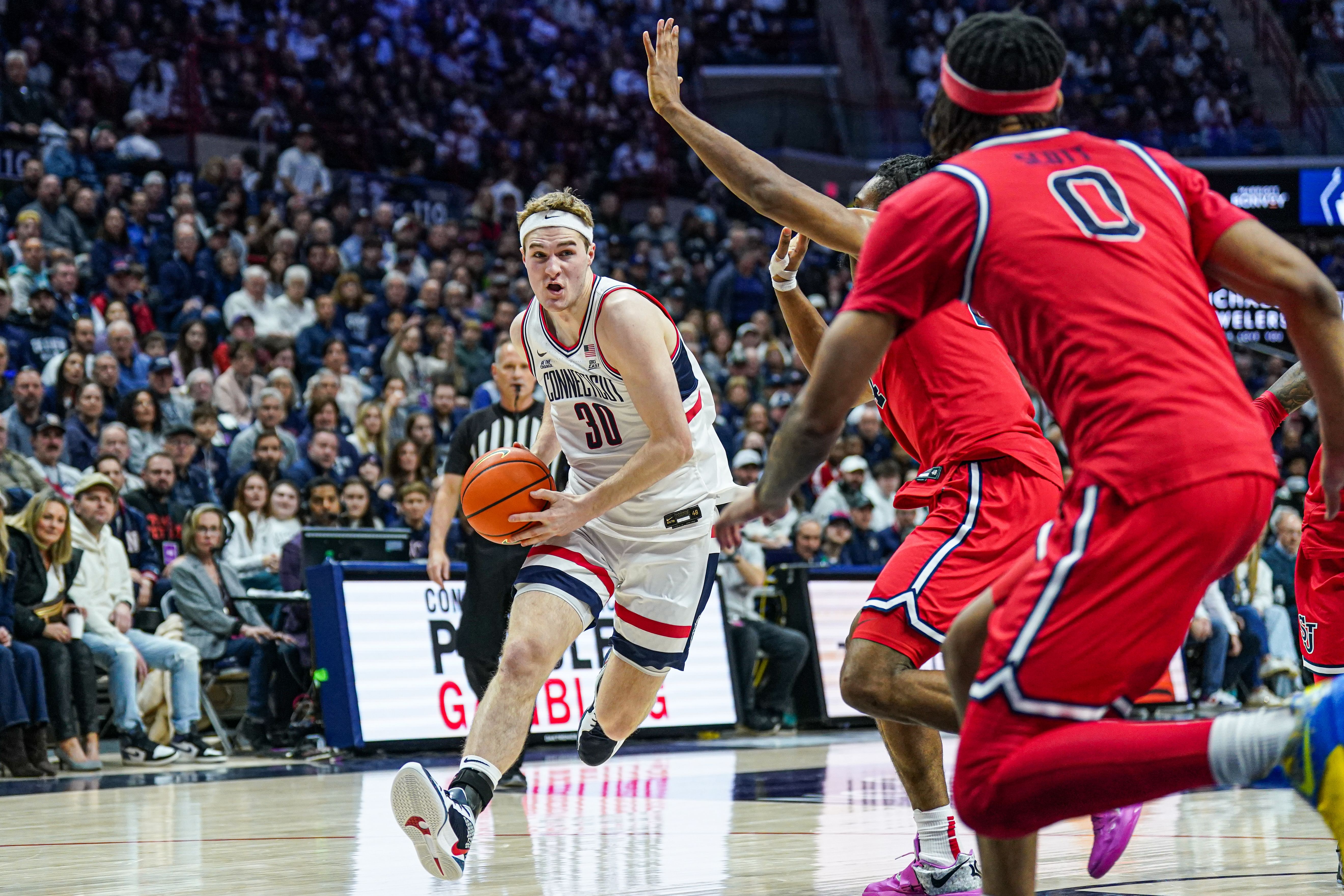 UConn Huskies forward Liam McNeeley (#30) drives the ball against the St. John&#039;s Red Storm in the first half at Harry A. Gampel Pavilion. Photo: Imagn