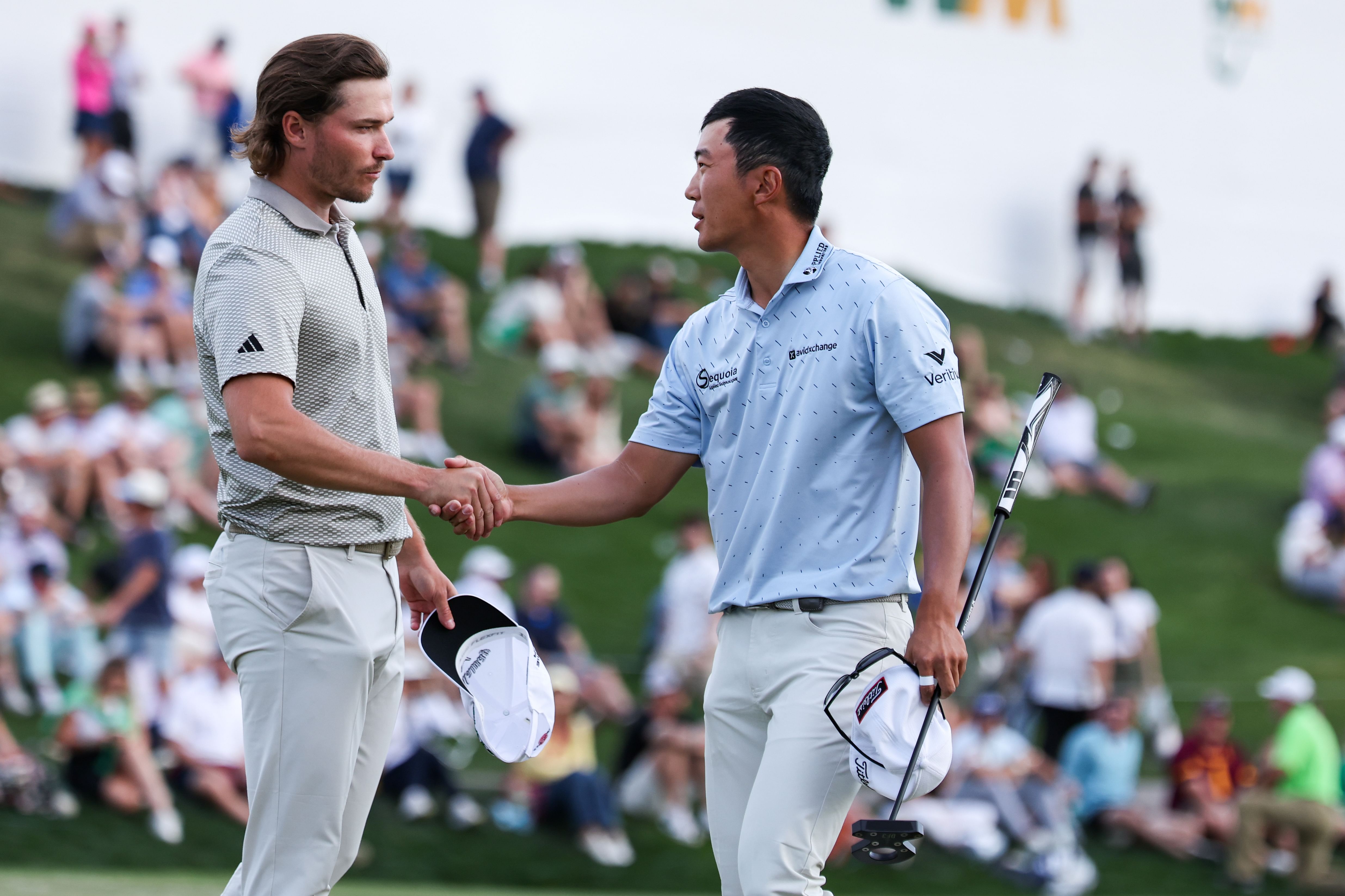 Michael Kim shakes hands with Rasmus H&oslash;jgaard after they both complete the 18th hole during the second round of the WM Phoenix Open - Source: Imagn