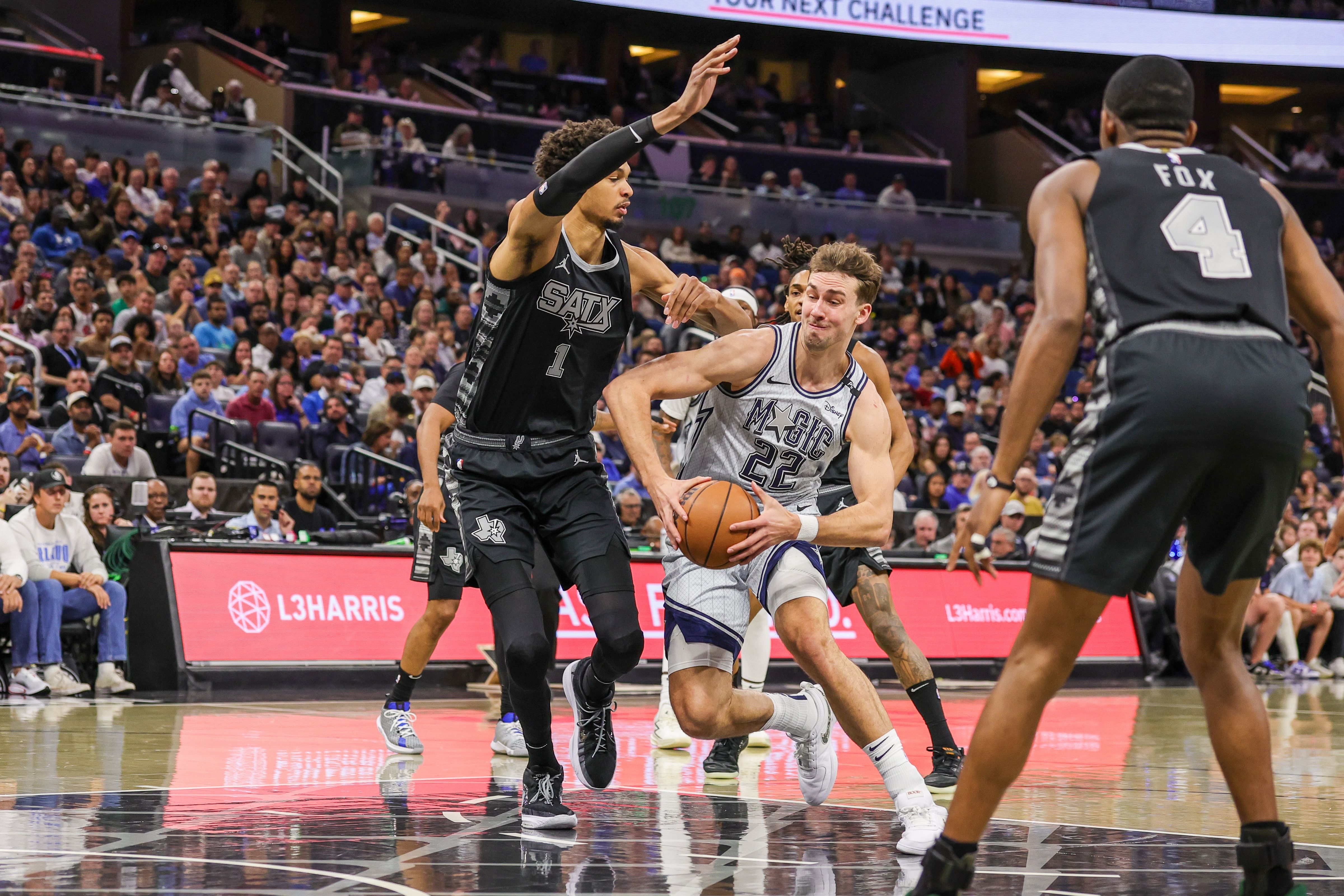 Feb 8, 2025; Orlando, Florida, USA; Orlando Magic forward Franz Wagner (22) drives to the basket against San Antonio Spurs center Victor Wembanyama (1) during the first quarter at Kia Center. Mandatory Credit: Mike Watters-Imagn Images - Source: Imagn