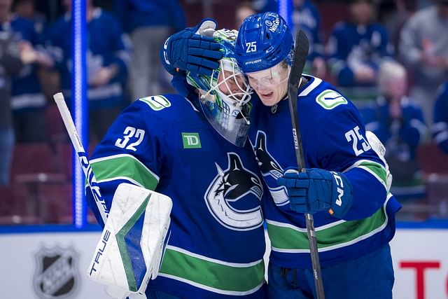 Feb 8, 2025; Vancouver, British Columbia, CAN; Vancouver Canucks goalie Kevin Lankinen (32) and defenseman Elias Pettersson (25) celebrate the victory against the Toronto Maple Leafs at Rogers Arena. Mandatory Credit: Bob Frid-Imagn Images - Source: Imagn