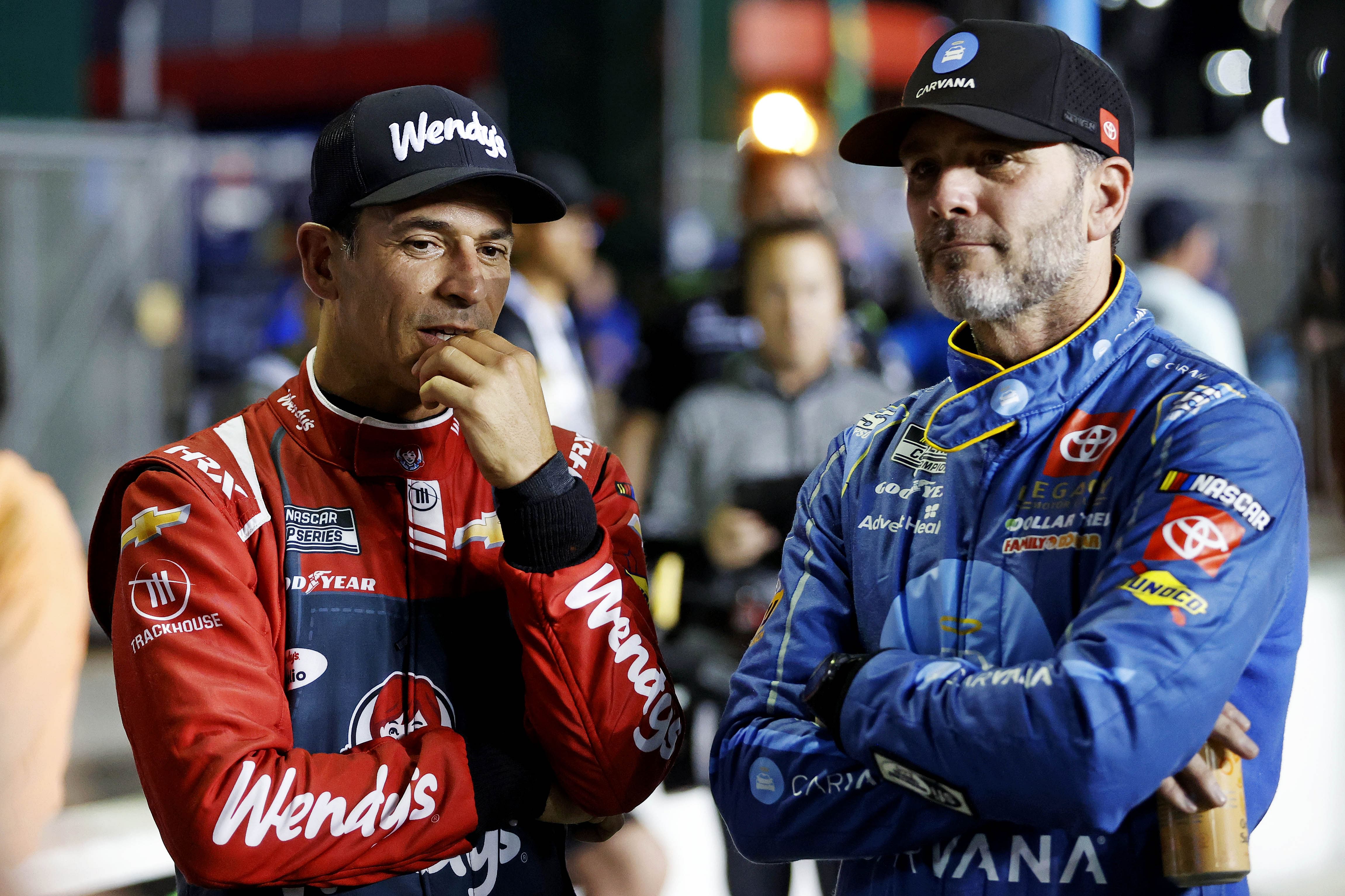 Helio Castroneves (L) and Jimmie Johnson (R) during qualifying for the Daytona 500 at Daytona International Speedway. - Source: Imagn