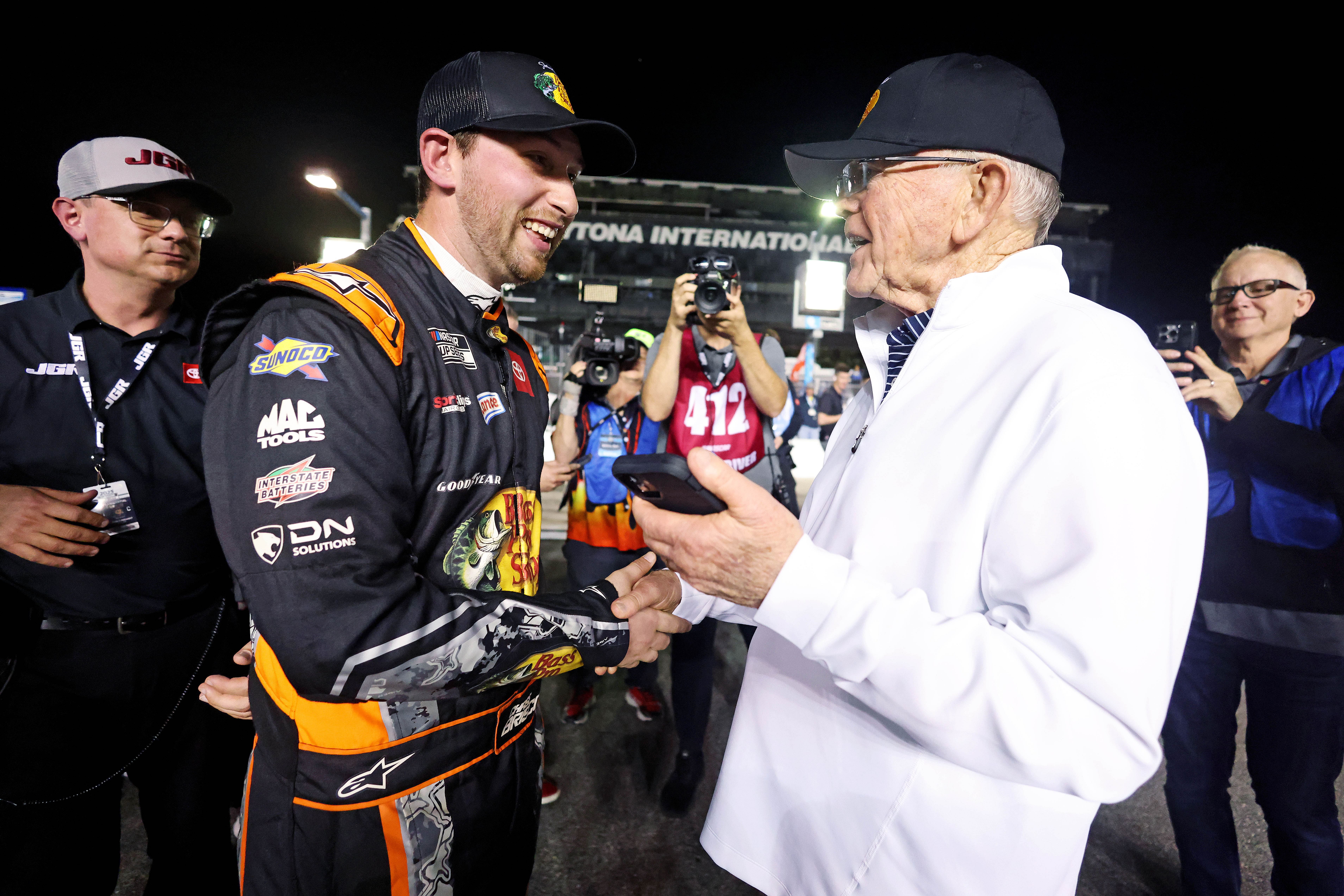 Chase Briscoe (19) celebrates with team owner Joe Gibbs after winning the pole during qualifying for the Daytona 500 at Daytona International Speedway - Source: Imagn