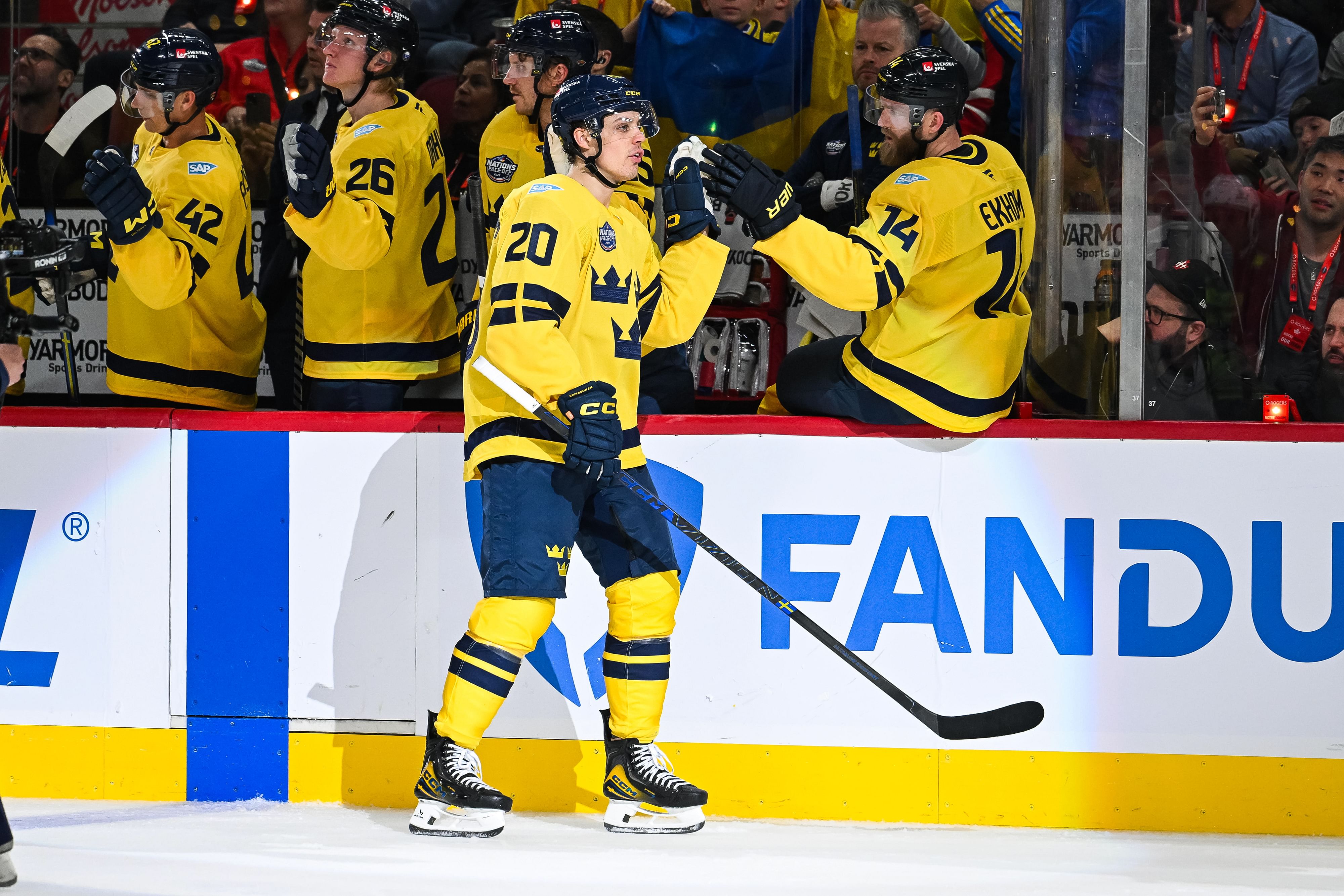 Feb 12, 2025; Montreal, Quebec, CAN; [Imagn Images direct customers only] Team Sweden forward Joel Eriksson (20) celebrates with teammates at the bench after scoring against Team Canada in the third period during a 4 Nations Face-Off ice hockey game at Bell Centre. Mandatory Credit: David Kirouac-Imagn Images - Source: Imagn