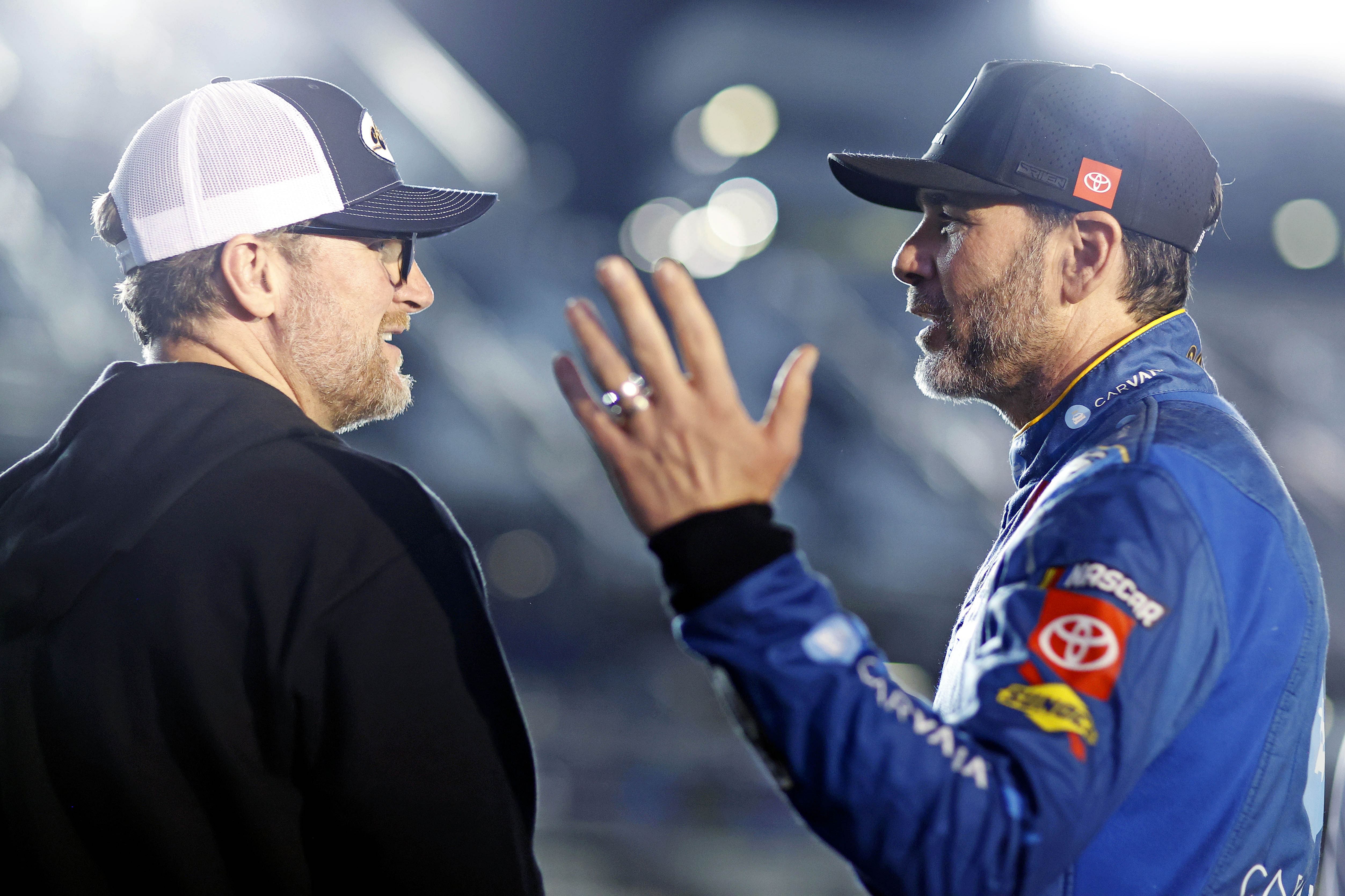 Dale Earnhardt Jr. talks with Jimmie Johnson during qualifying for the Daytona 500 - Source: Imagn