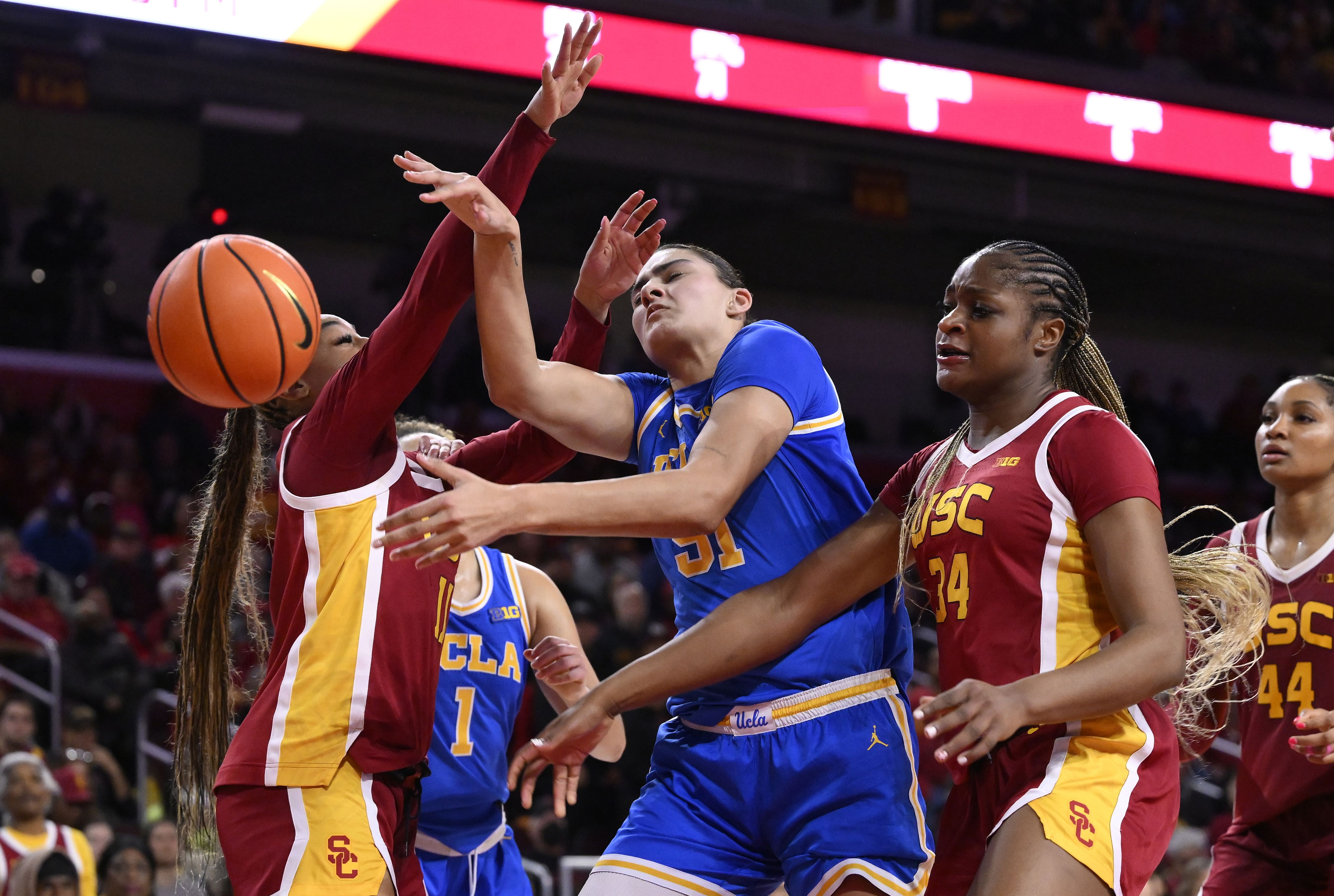 USC Trojans guard Kennedy Smith (11), UCLA Bruins center Lauren Betts (51) and USC Trojans center Clarice Akunwafo (34) battle for the rebound during the third quarter at Galen Center. Photo: Imagn