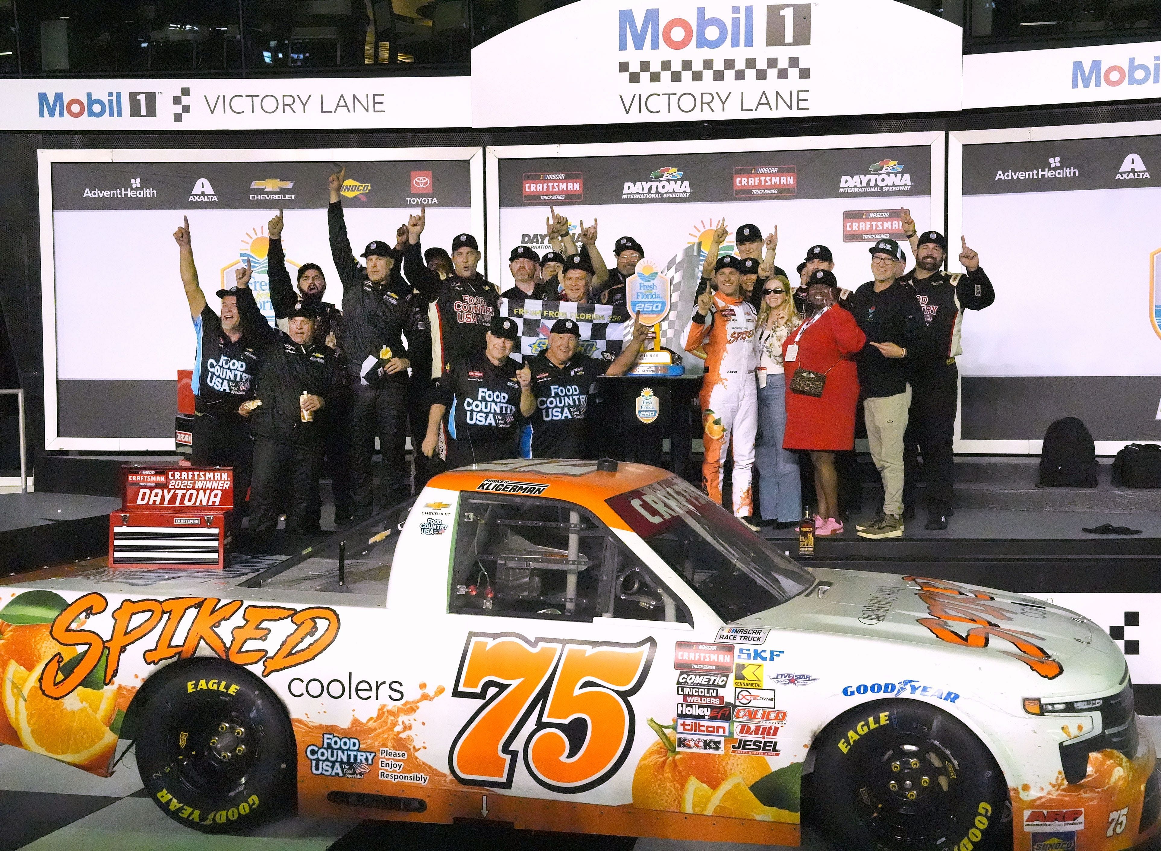 Parker Kligerman no. 75 Chevrolet celebrates in Victory Lane, with the crew and sponcers, Friday night February 14, 2025 at winning the Fresh From Florida 250 at Daytona International Speedway. - Source: Imagn