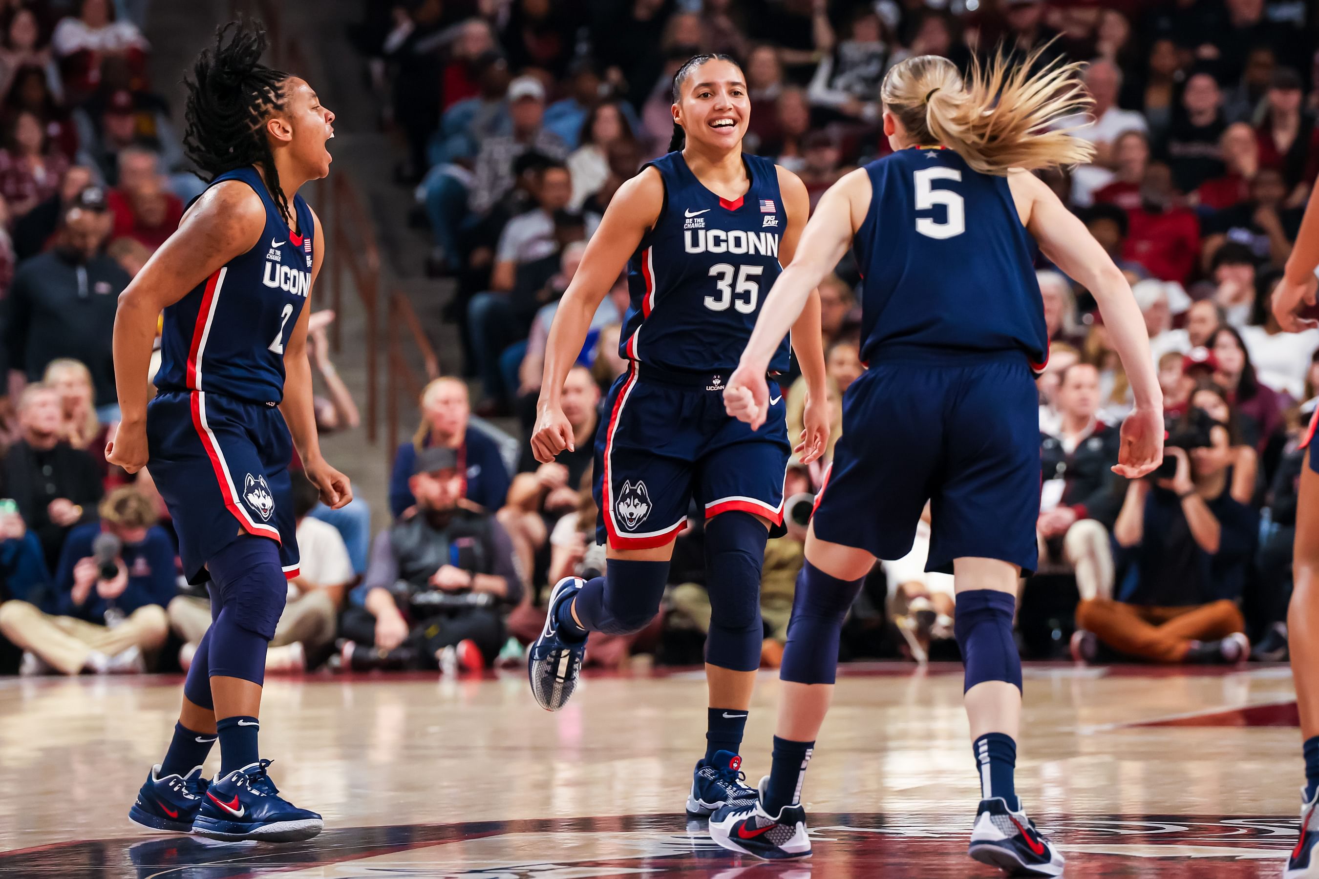 UConn Huskies guard KK Arnold (2), guard Azzi Fudd (35) and guard Paige Bueckers (5) celebrate a three-point basket against the South Carolina Gamecocks in the first half at Colonial Life Arena. Photo: Imagn