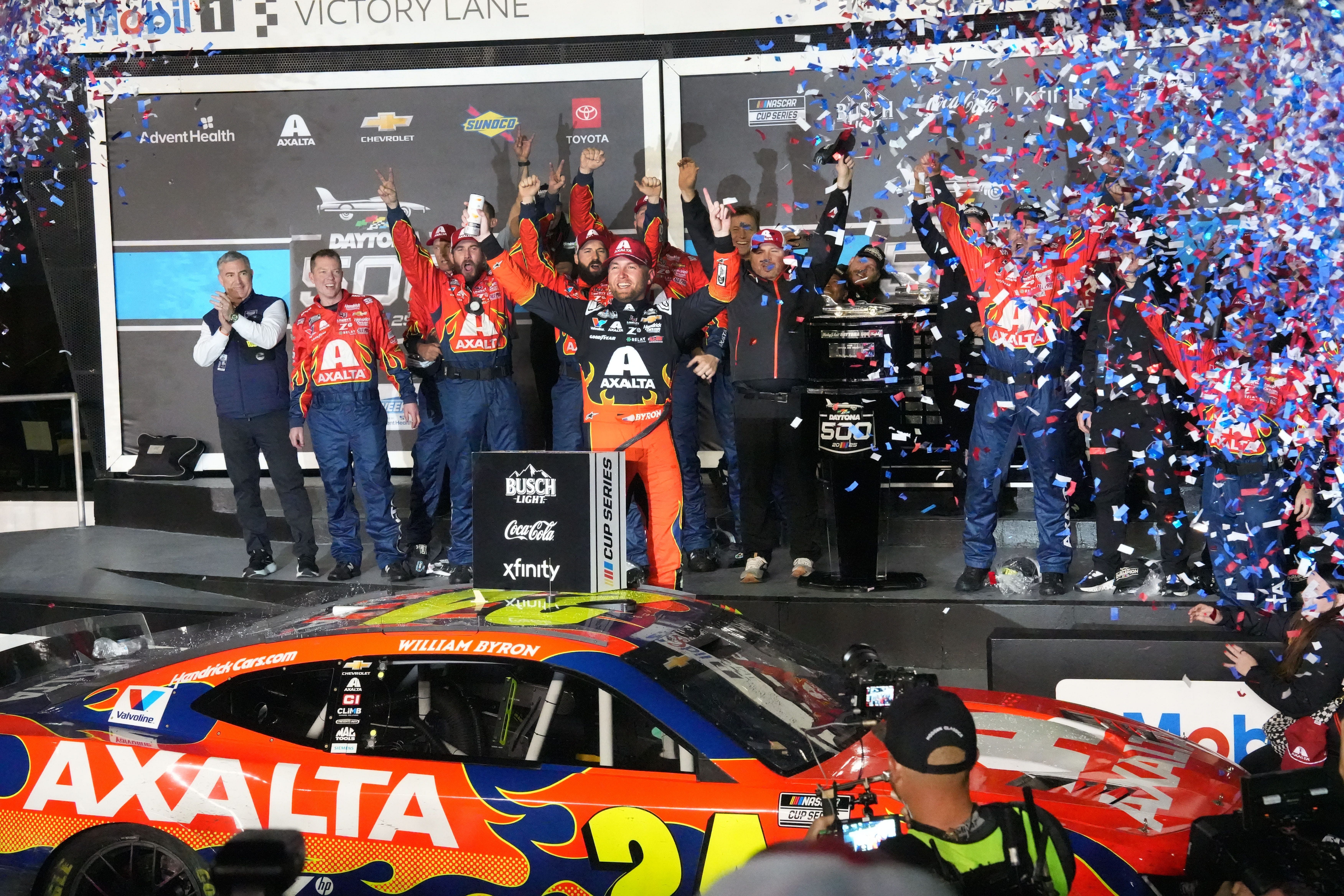 William Byron climbs out of his no. 24 Chevrolet in Mobil 1 Victory Lane, Sunday, February 16, 2025, as confetti fills the air after winning the Daytona 500 at Daytona International Speedway. - Source: Imagn