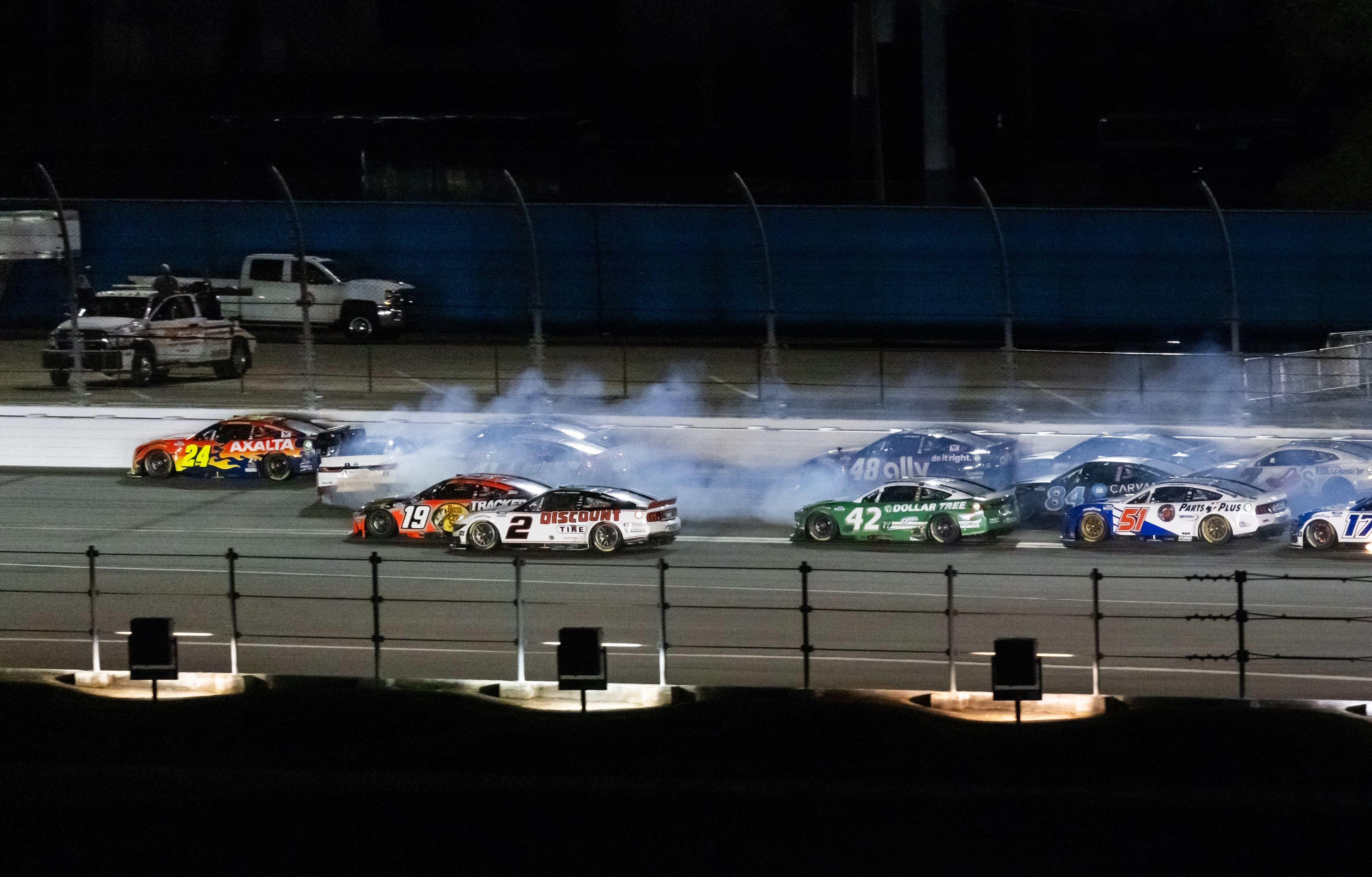 William Byron (24) avoids the spinning car of Denny Hamlin (11) on the last lap of the Daytona 500 at Daytona International Speedway. - Source: Imagn