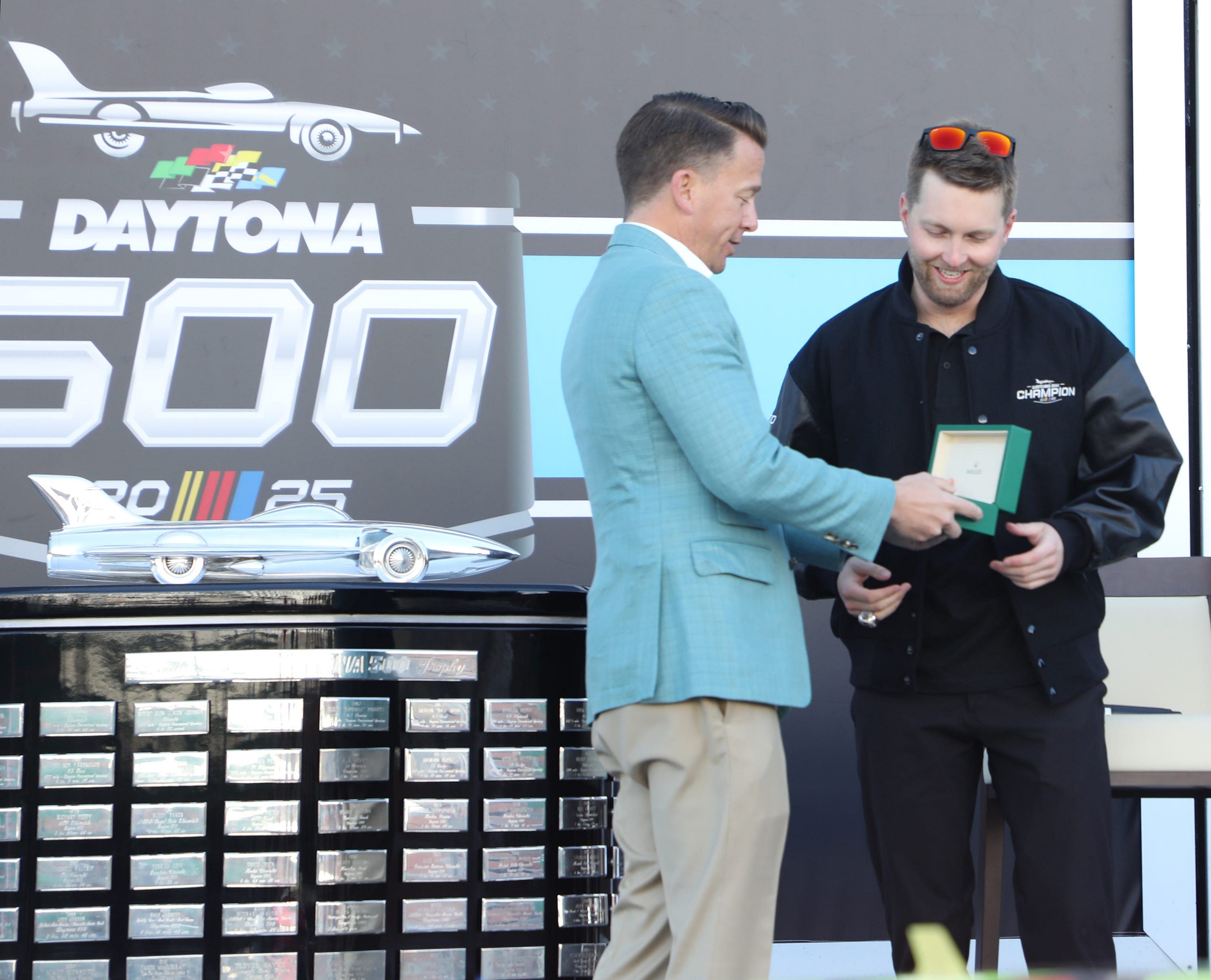 Frank Kelleher hands William Byron his new Rolex watch after he won the Daytona 500 - Source: Imagn