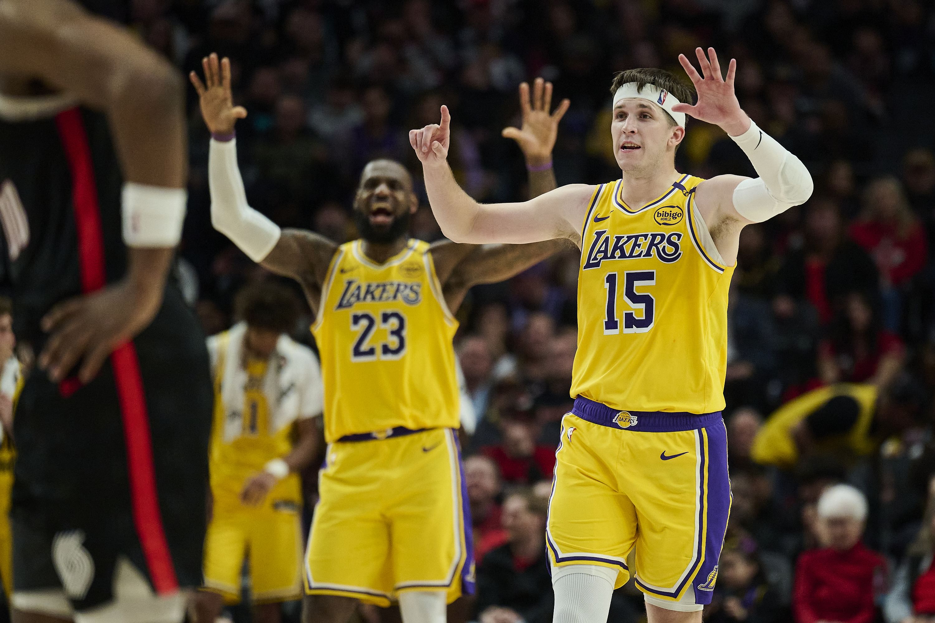 Feb 20, 2025; Portland, Oregon, USA; Los Angeles Lakers guard Austin Reaves (15) and forward LeBron James (23) signal to teammates during the second half against the Portland Trail Blazers at Moda Center. Mandatory Credit: Troy Wayrynen-Imagn Images - Source: Imagn