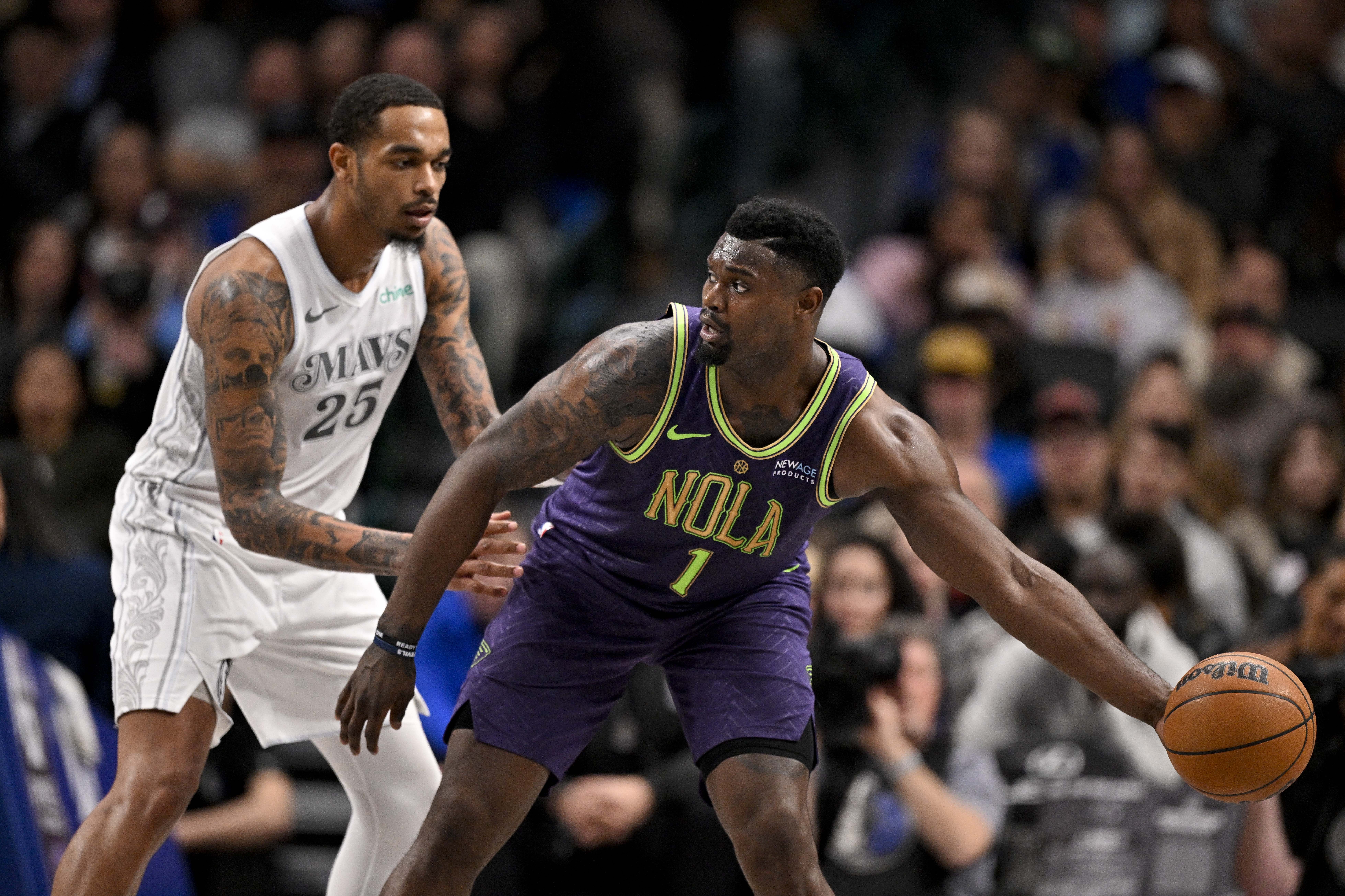 New Orleans Pelicans forward Zion Williamson looks to move the ball past Dallas Mavericks forward P.J. Washington at the American Airlines Center. Photo Credit: Imagn