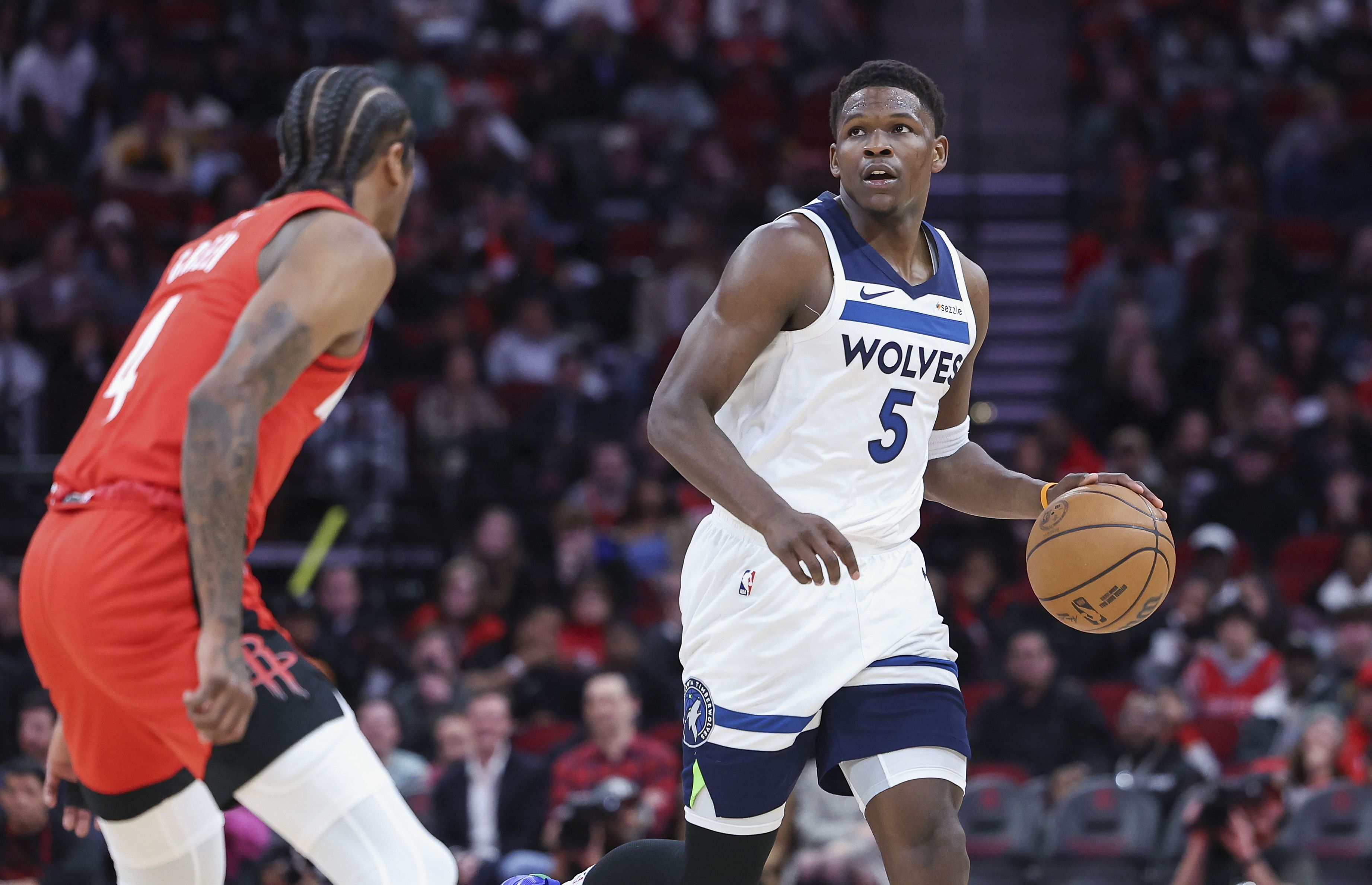 Minnesota Timberwolves guard Anthony Edwards dribbles the ball as Houston Rockets guard Jalen Green defends at Toyota Center. Photo Credit: Imagn