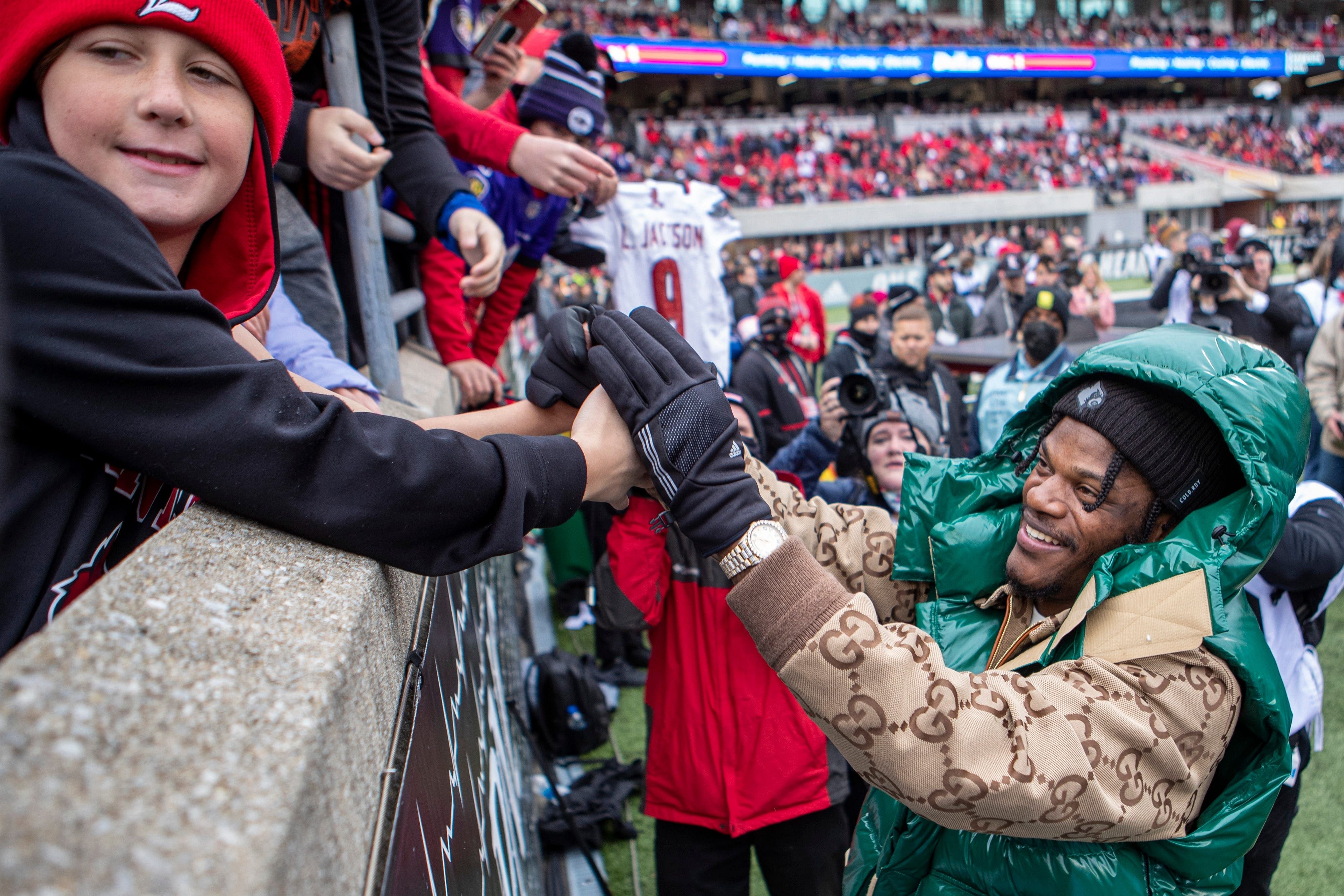 Lamar Jackson greets Louisville fans during the game against Syracuse on Saturday as Lamar Jackson