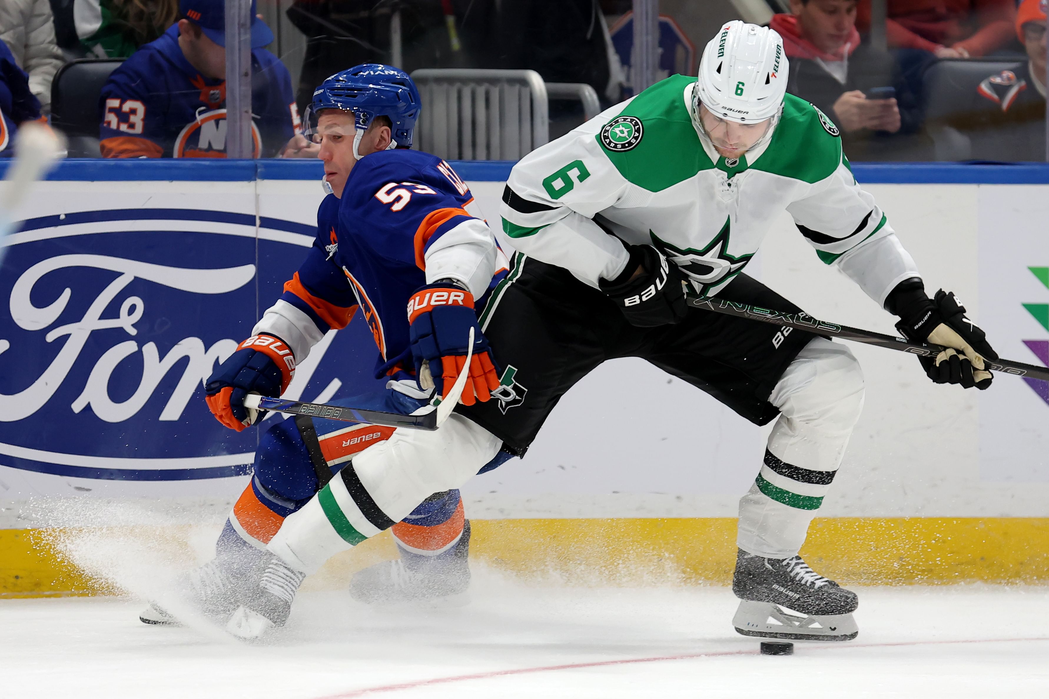 Feb 23, 2025; Elmont, New York, USA; New York Islanders center Casey Cizikas (53) fights for the puck against Dallas Stars defenseman Lian Bichsel (6). (credit: IMAGN)