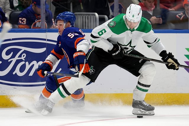 Feb 23, 2025; Elmont, New York, USA; New York Islanders center Casey Cizikas (53) fights for the puck against Dallas Stars defenseman Lian Bichsel (6). (credit: IMAGN)