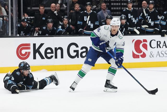 Feb 23, 2025; Salt Lake City, Utah, USA; Vancouver Canucks center Elias Pettersson (40) looks to shoot as Utah Hockey Club center Alexander Kerfoot (15) goes to the ice to defend during the third period at Delta Center. Mandatory Credit: Rob Gray-Imagn Images - Source: Imagn