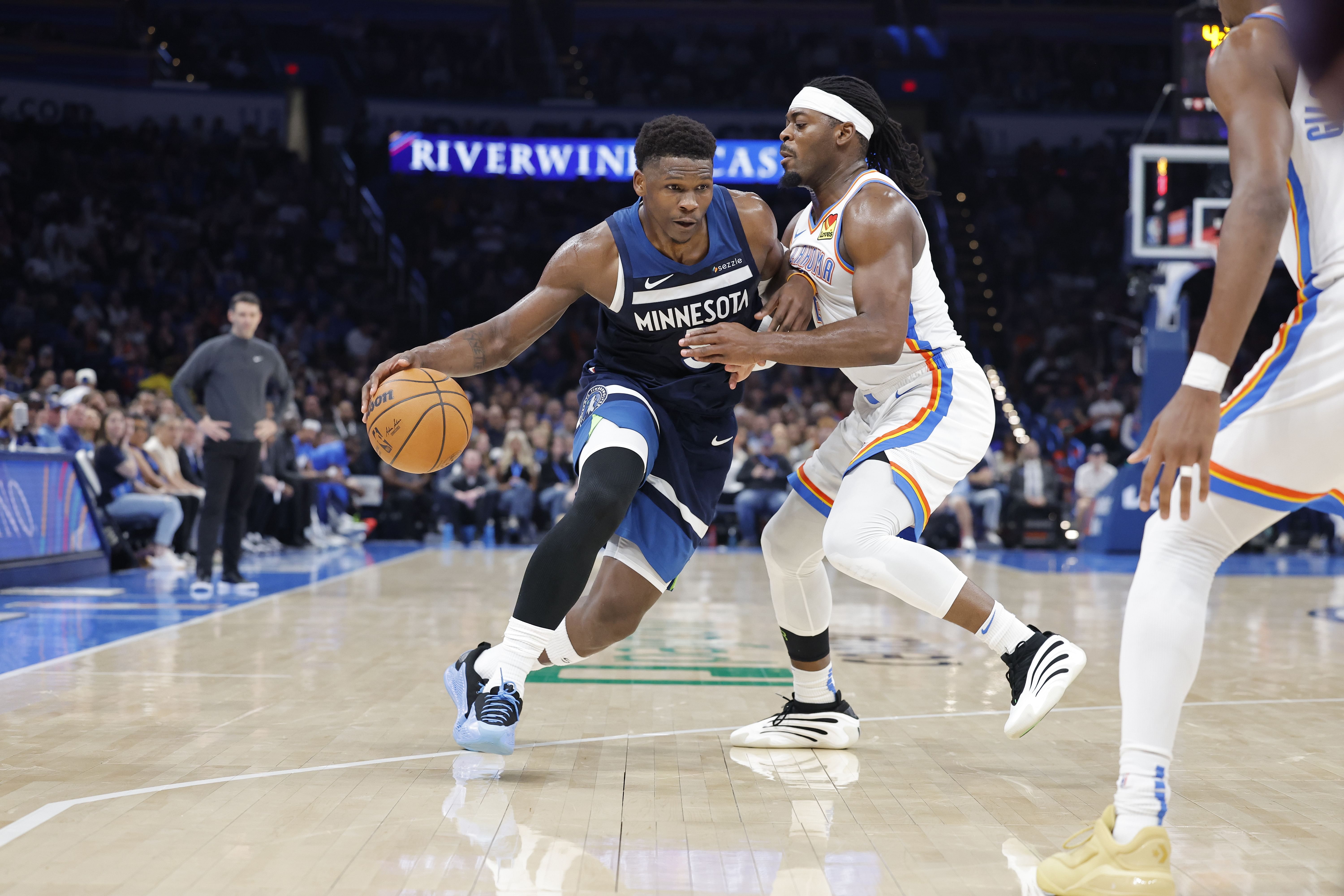 Minnesota Timberwolves guard Anthony Edwards moves the ball down the court as Oklahoma City Thunder guard Luguentz Dort defends at Paycom Center. Photo Credit: Imagn