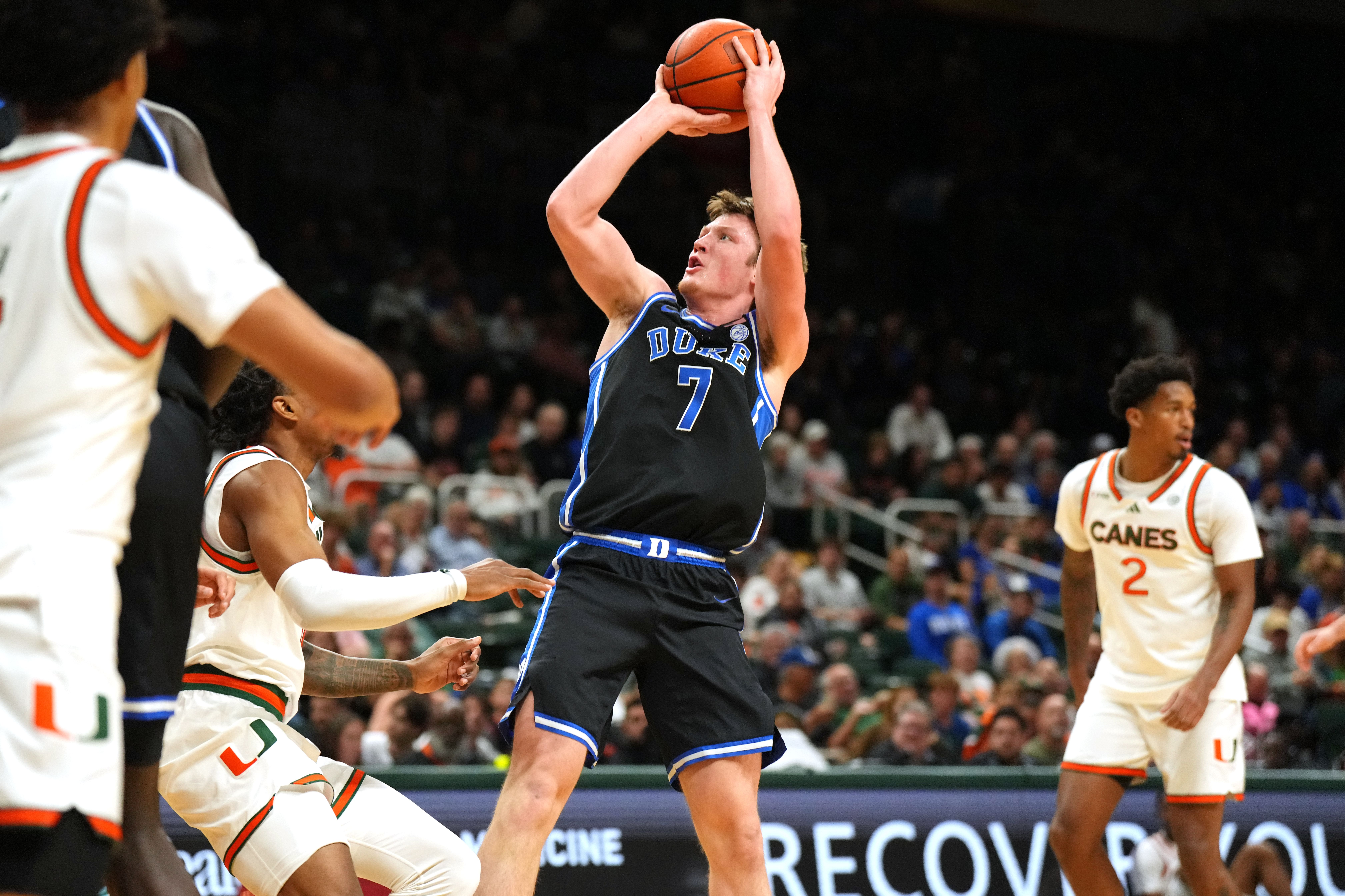 Duke Blue Devils guard Kon Knueppel (7) takes a shot as Miami defenders close in during the first half at Watsco Center. Photo: Imagn