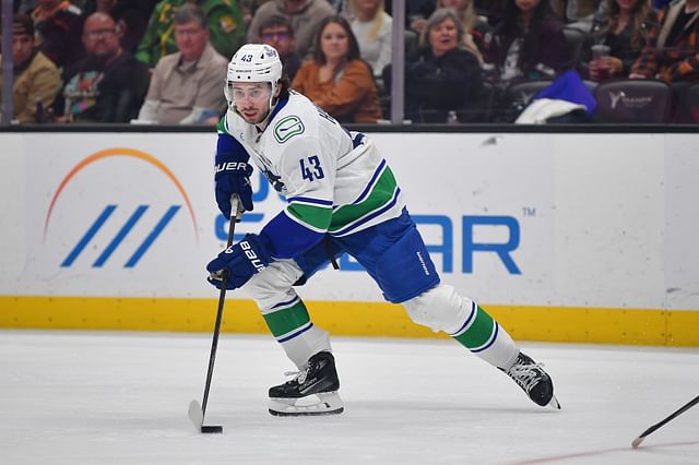 Feb 27, 2025; Anaheim, California, USA; Vancouver Canucks defenseman Quinn Hughes (43) controls the puck against the Anaheim Ducks during the third period at Honda Center. Mandatory Credit: Gary A. Vasquez-Imagn Images - Source: Imagn