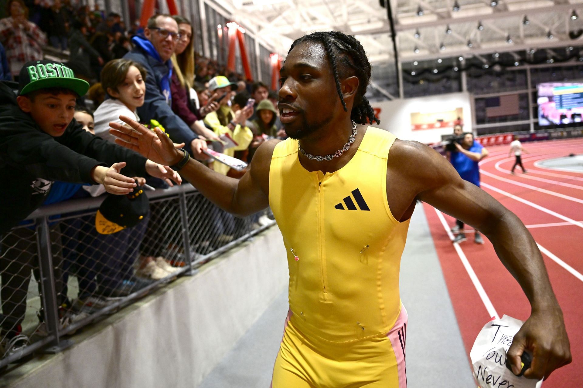 Lyles celebrates with the fans after his 60m victory at the 2025 New Balance Indoor Grand Prix in Boston (Image via: Getty Images)