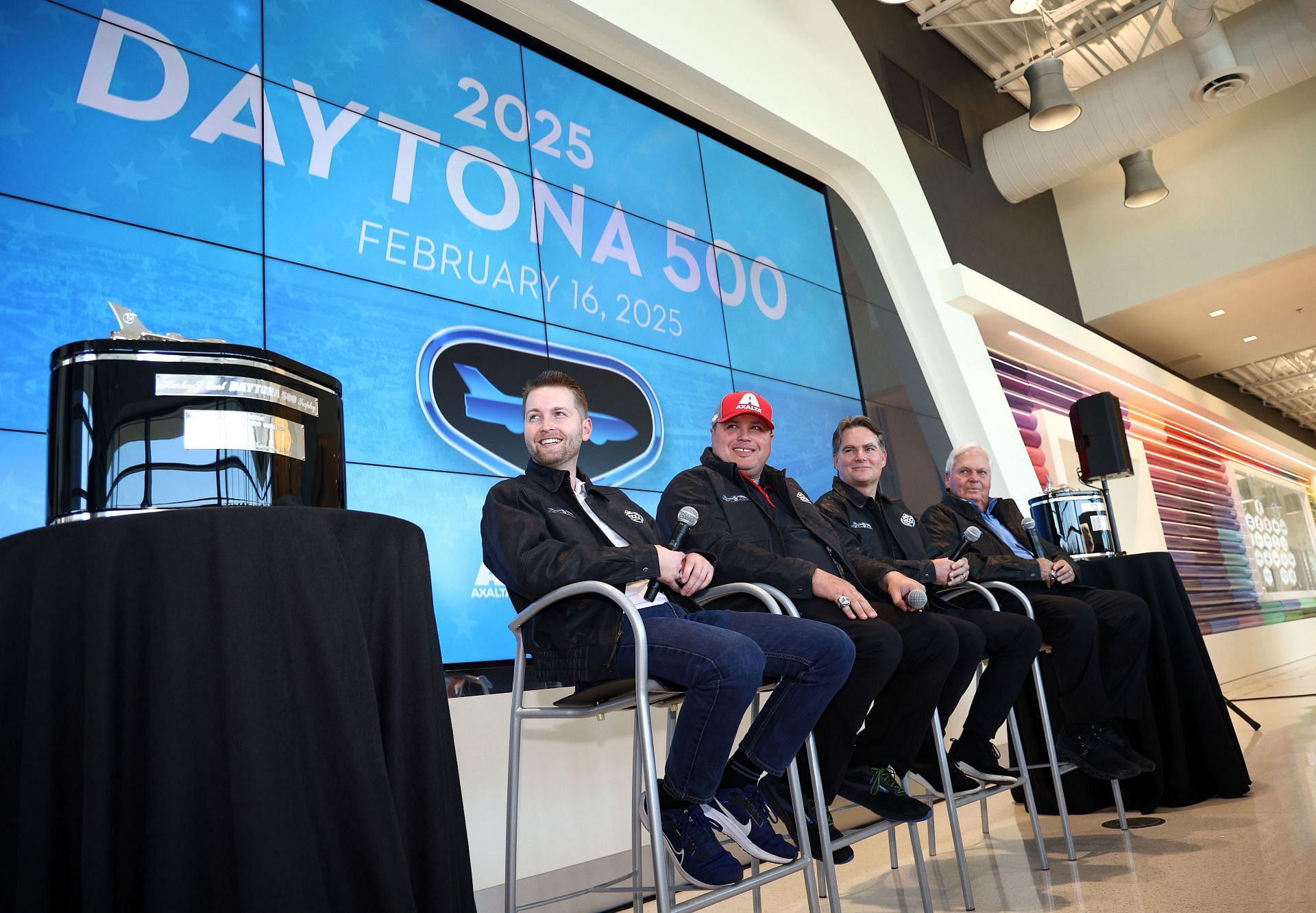 William Byron, Rudy Fugle, Jeff Gordon, and Rick Hendrick look on as the date for the 2025 Daytona 500 is revealed during the 2024 Daytona 500 Champion Celebration at Hendrick Motorsports Campus on February 26, 2024 - Source: Getty