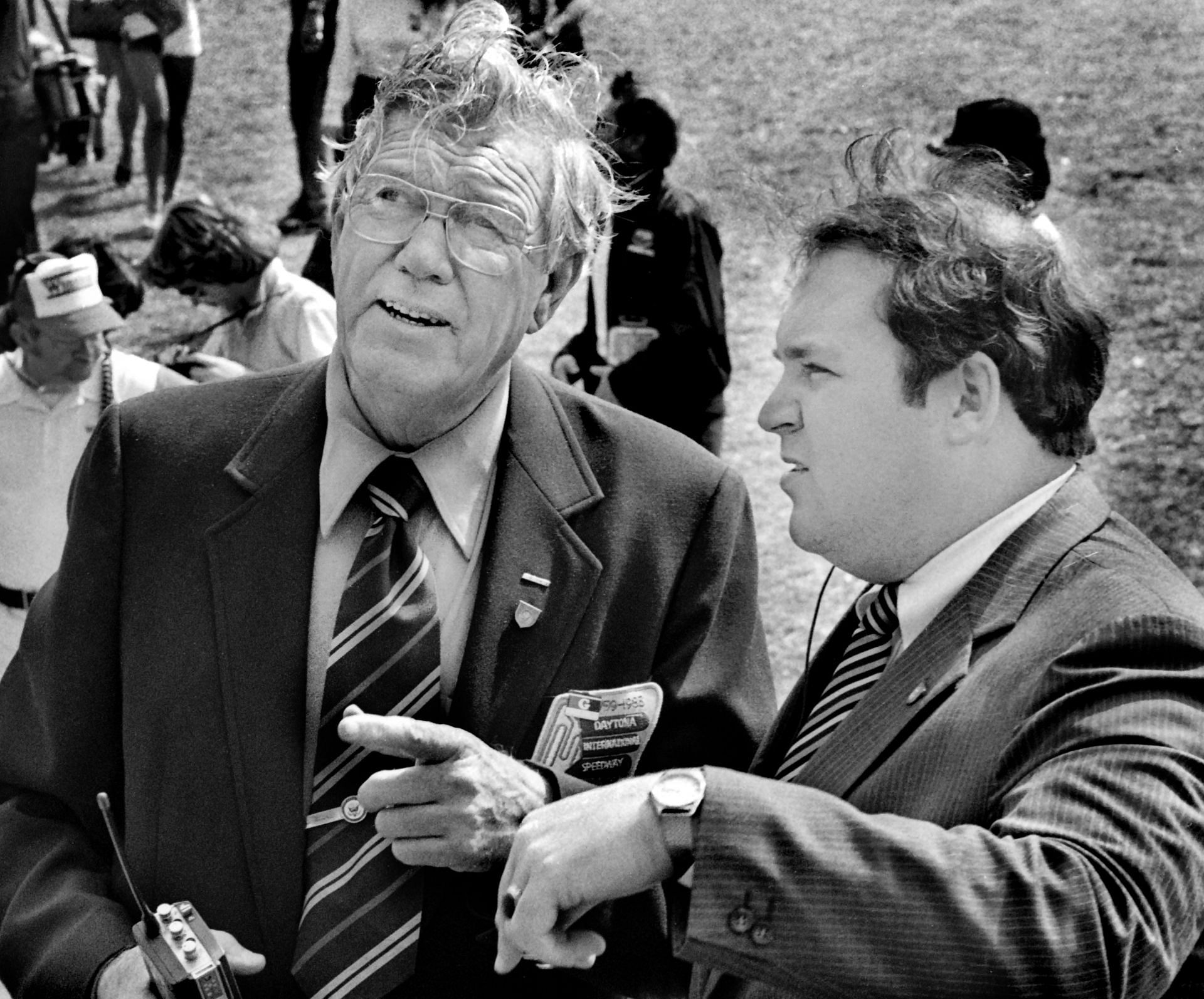 NASCAR founder and former CEO Bill France Sr., left, talks with a U.S. Secret Service agent regarding security for Vice President George H.W. Bush prior to the start of the 1983 Daytona 500 - Source: Getty