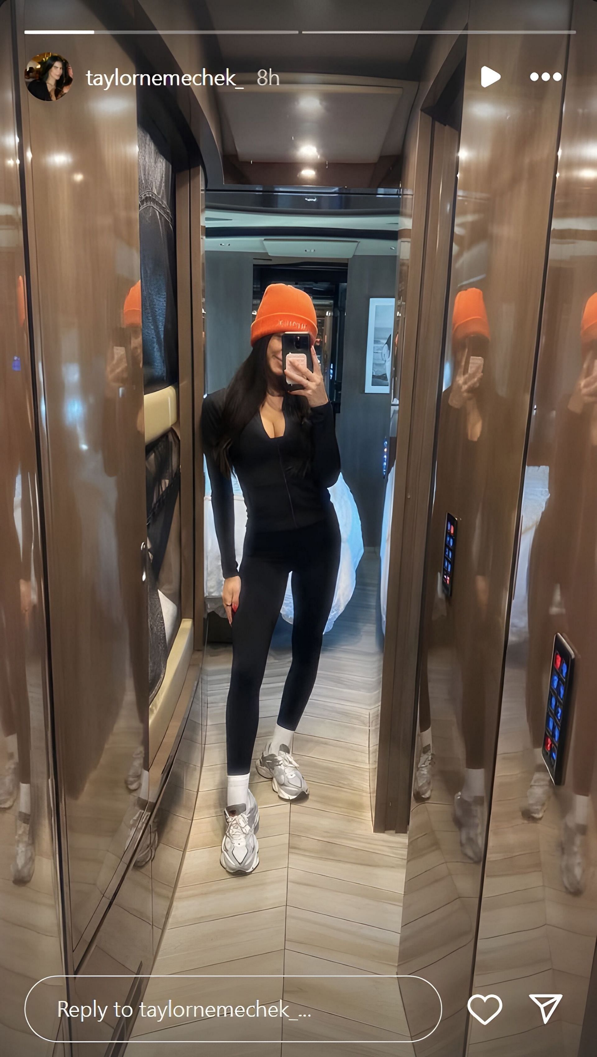 John Hunter Nemechek&#039;s wife Taylor in an all-black workout ensemble with bright orange beanie and grey sneakers. Source: via Instagram, @taylor nemechek