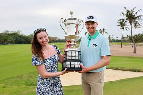 Brian Campbell poses with the trophy and his girlfriend Kelsi McKee after the final round of the Mexico Open - Source: Getty