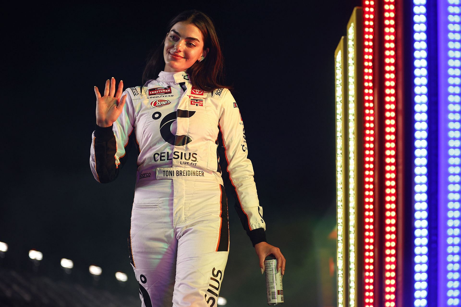 Toni Breidinger waves to fans as she walks onstage during driver intros prior to the NASCAR Craftsman Truck Series - Source: Getty