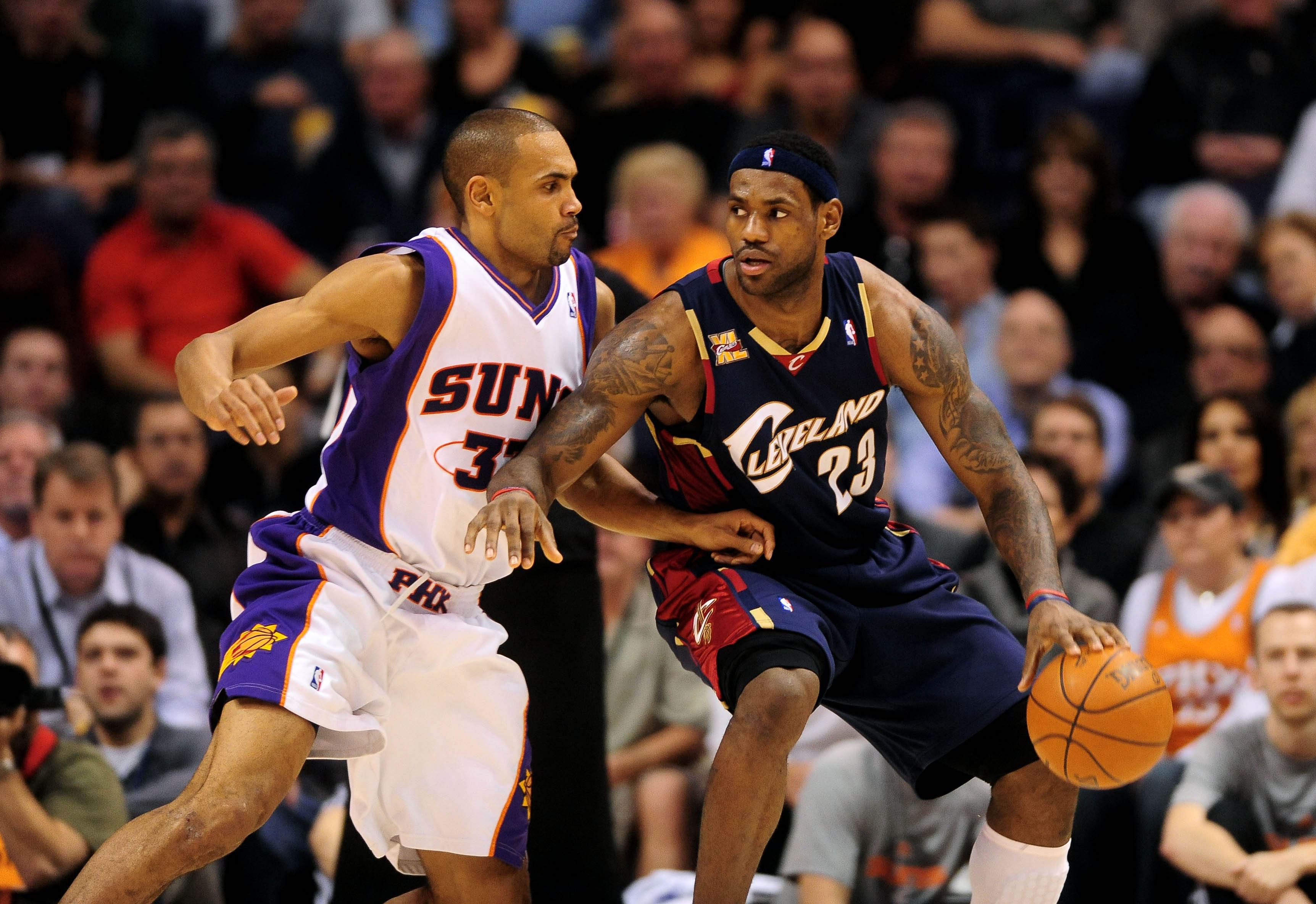 LeBron James moves the ball under pressure from Phoenix Suns forward Grant Hill at the US Airways Center. Cleveland defeated Phoenix 109-91. Mandatory Credit: Mark J. Rebilas-Imagn Images