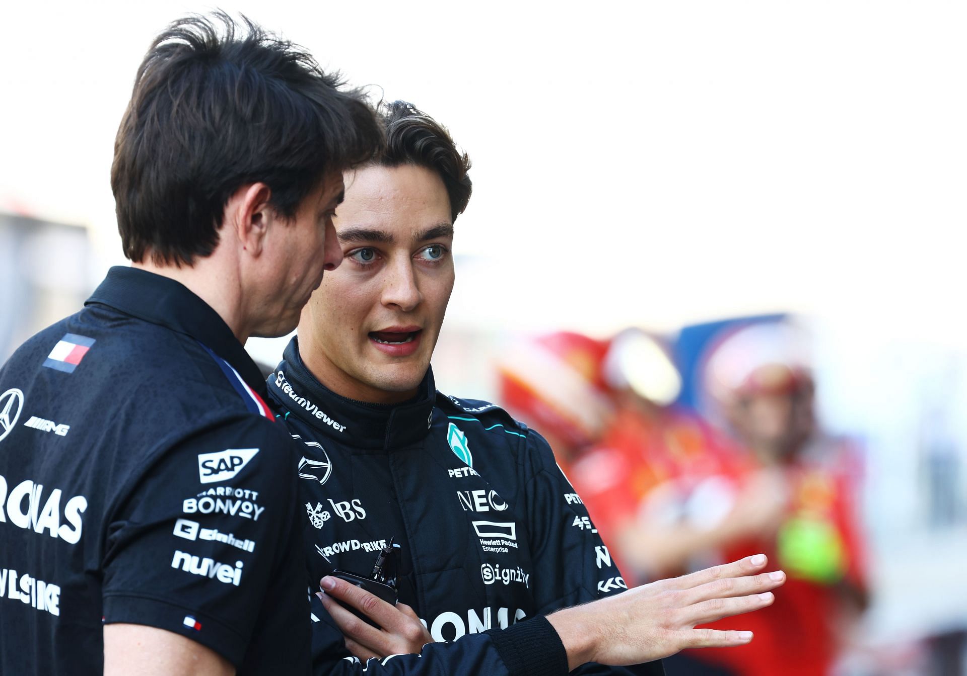 George Russell of Great Britain and Mercedes talks with Mercedes GP Executive Director Toto Wolff at the Mercedes team photo in the Pitlane during previews- Source: Getty