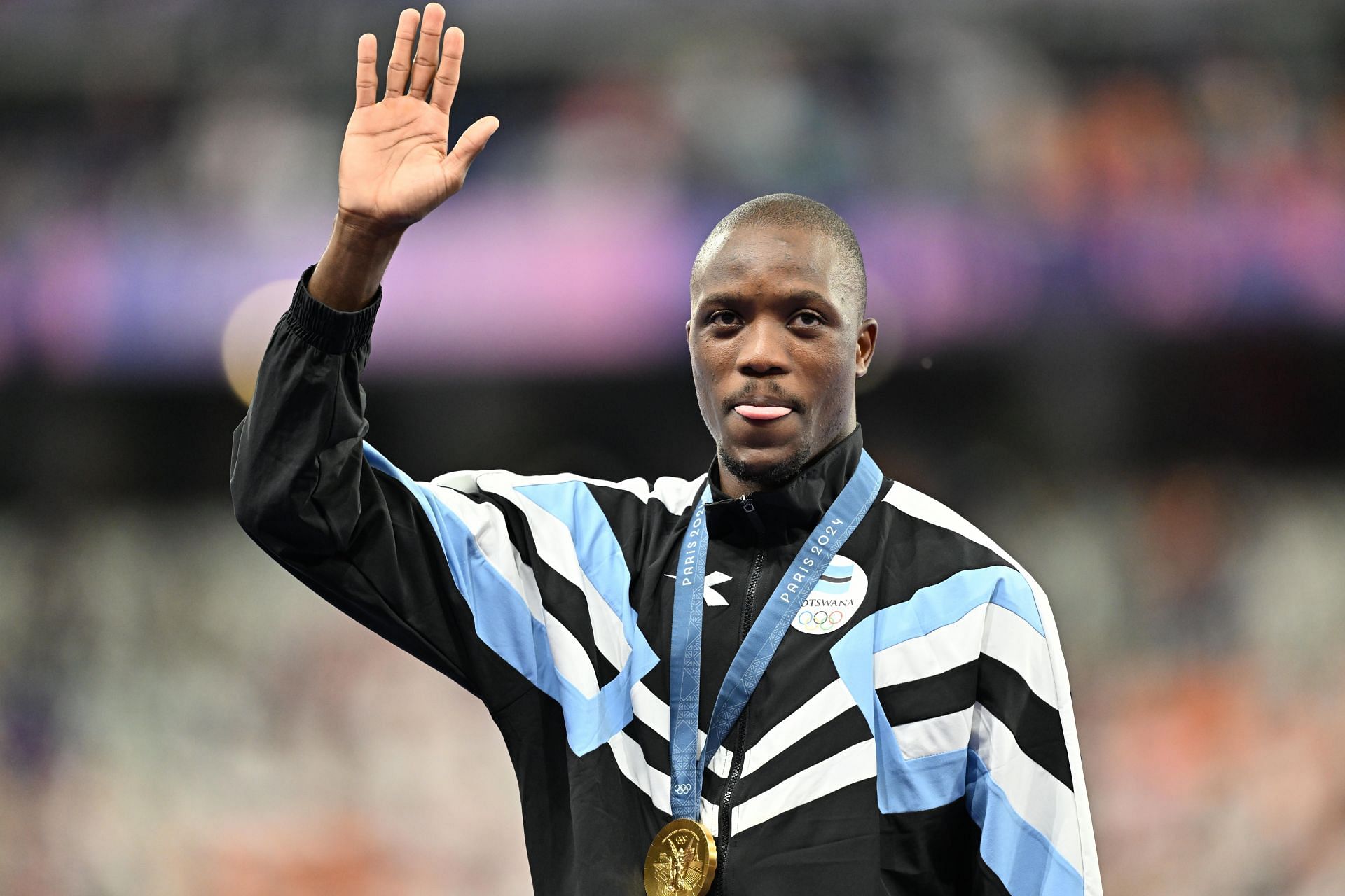 Letsile Tebogo celebrates on the podium after defeating Noah Lyles and Kenny Bednarek in the 200m at the Paris Olympics | Source: Getty Images