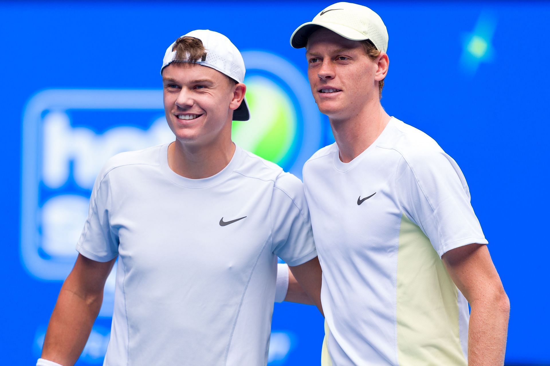 Holger Rune and Jannik Sinner (R) pictured at the 2025 Australian Open - Image Source: Getty