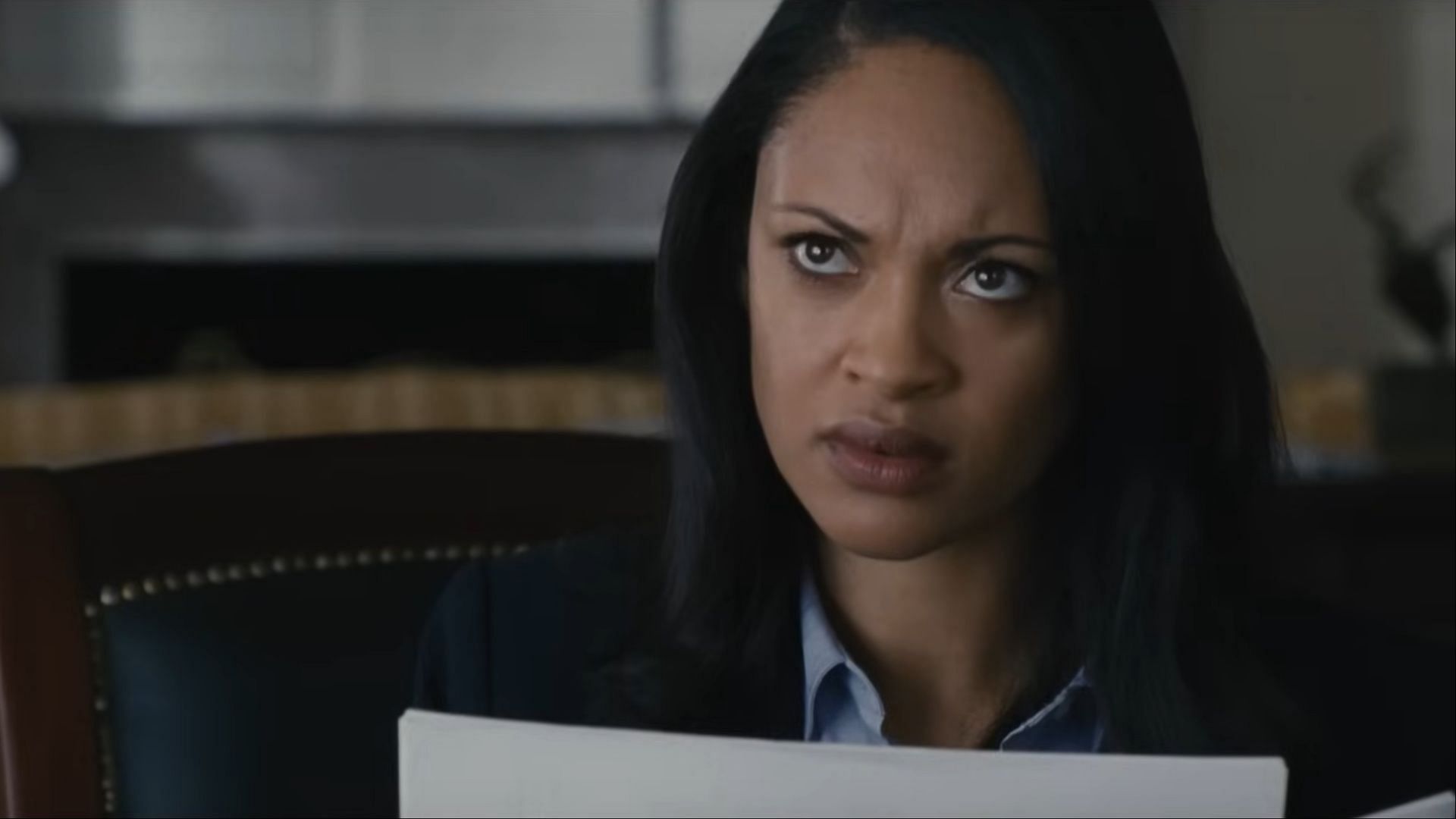 Cynthia Addai-Robinson as Marybeth Medina - Medina, a determined Treasury agent, examines critical documents with a sharp gaze (Image via Prime video)