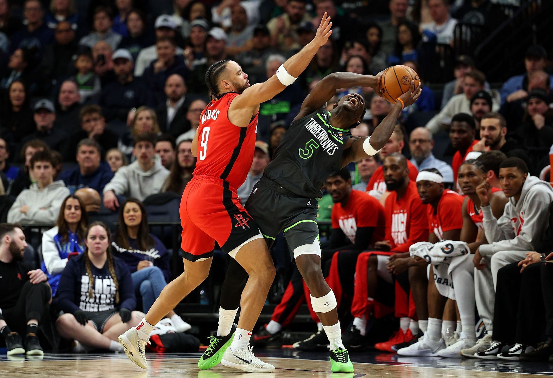 Anthony Edwards gives an earful to Dillon Brooks in their lively back-and-forth. - Photo by GETTY