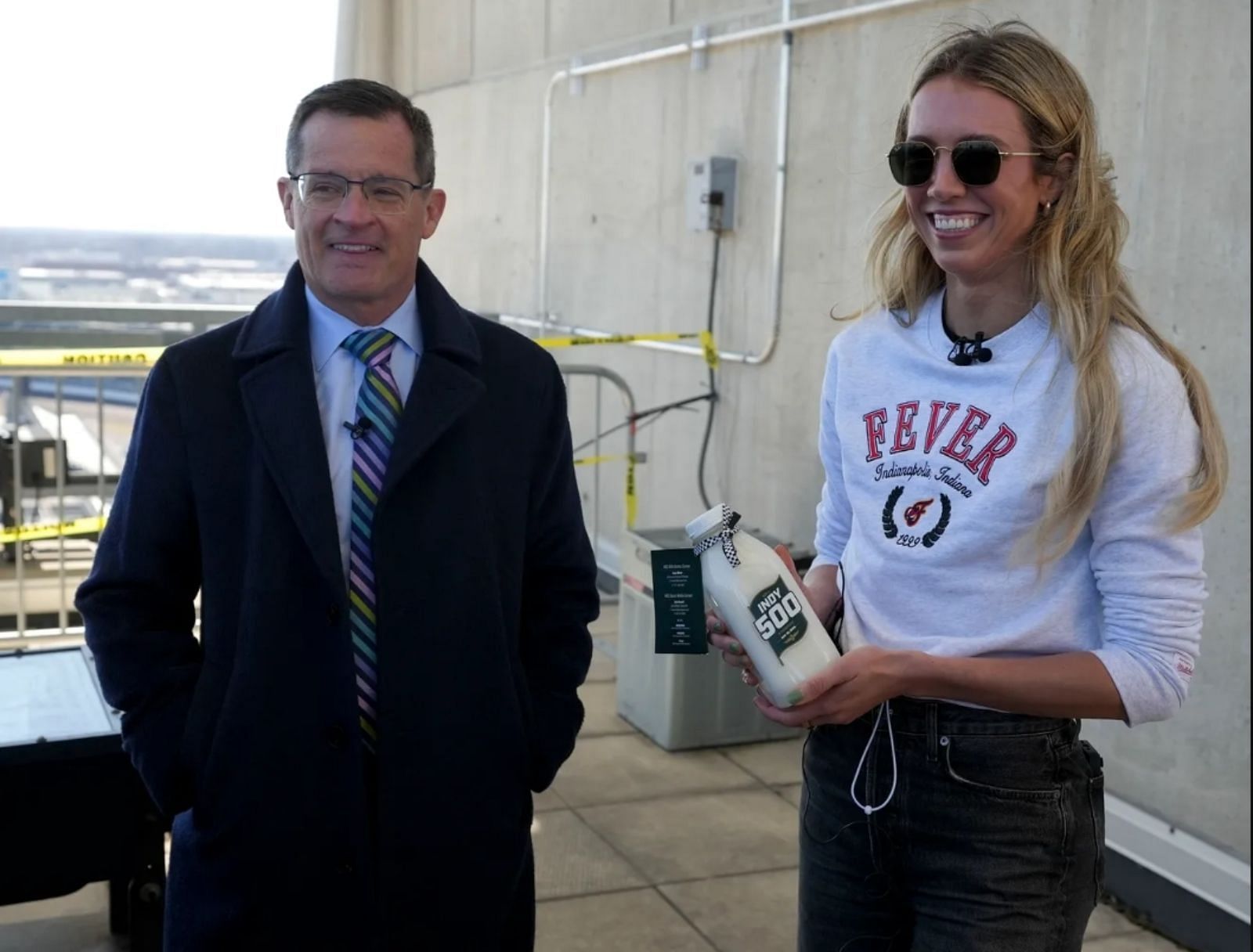 Lexie Hull (right) and IndyCar president Doug Boles (left) posing with the Indy500 milk - Source: IndyStar