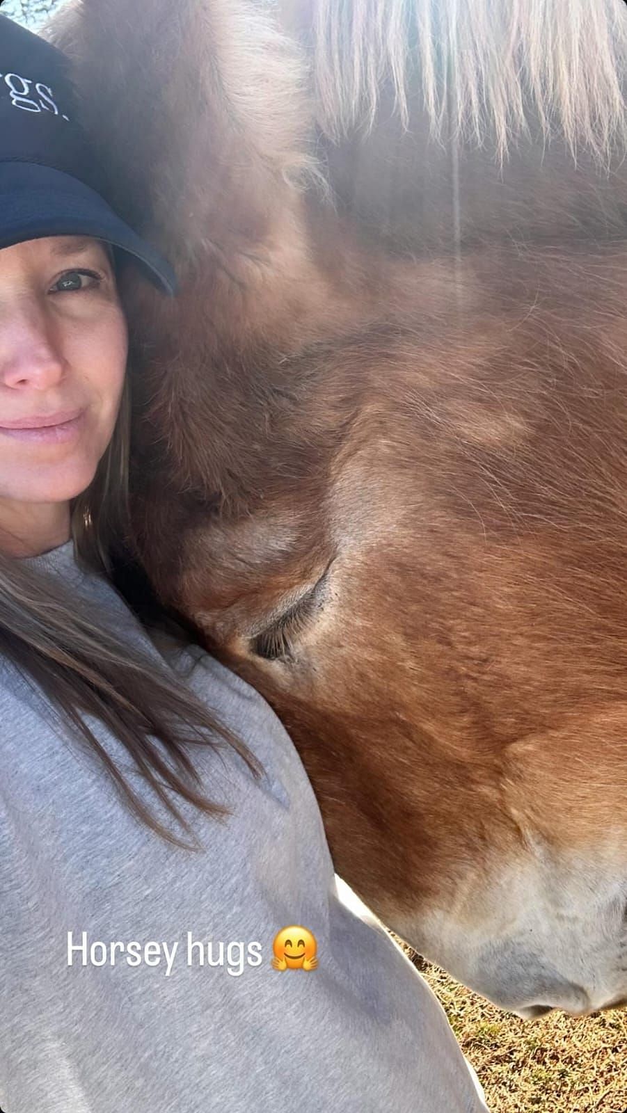 Amy Earnhardt shared an adorable moment with a brown horse (Source: @amyearnhardt via Instagram)