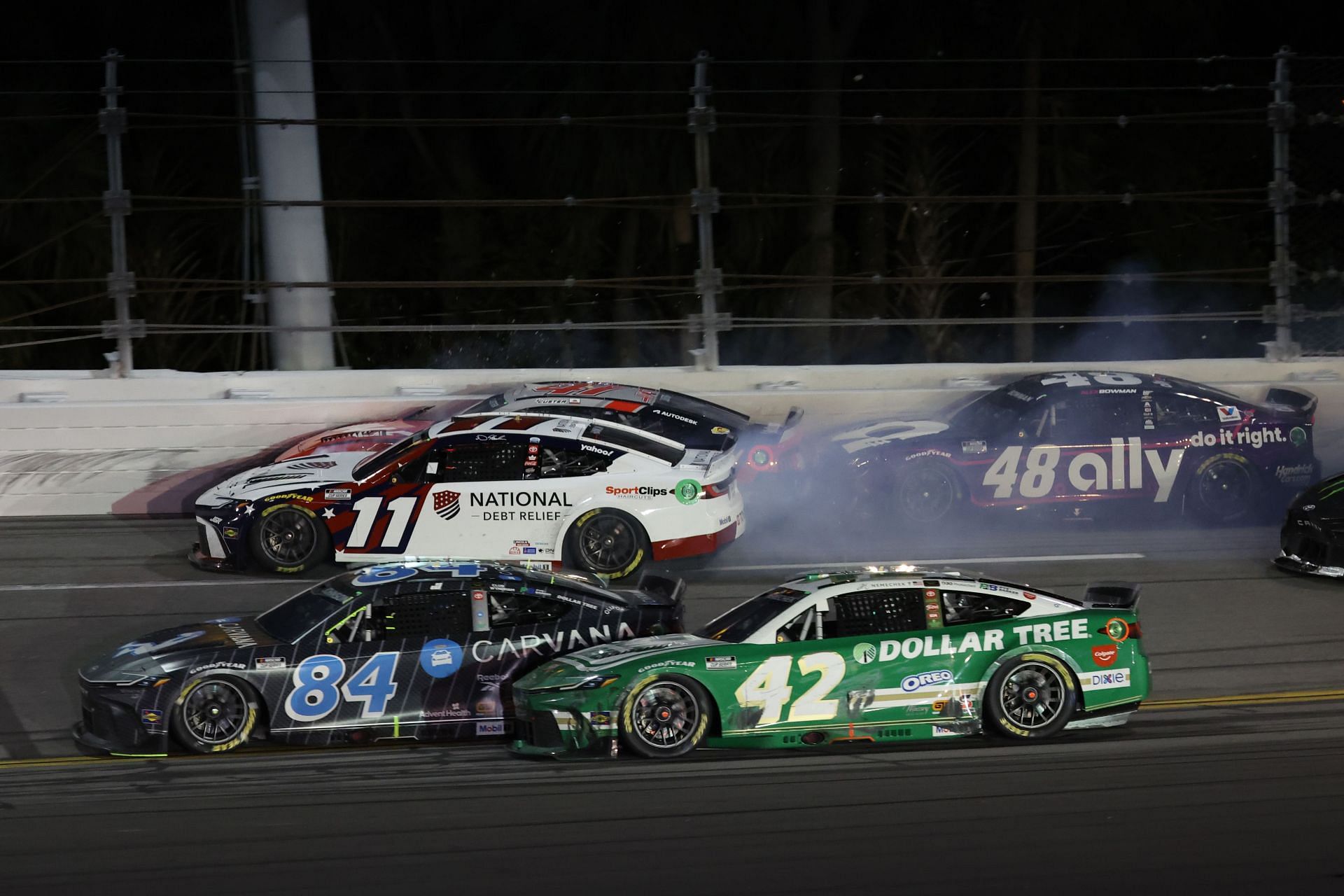 Denny Hamlin, driver of the #11 National Debt Relief Toyota, Cole Custer, driver of the #41 HaasTooling.com Ford and Alex Bowman, driver of the #48 Ally Chevrolet spin after an on-track incident - Source: Getty