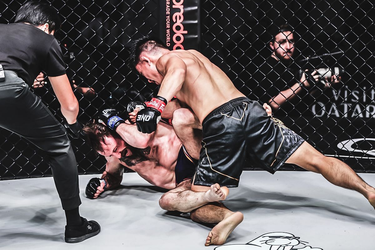 Joshua Pacio (top) hammers Jarred Brooks with strikes [Photo via ONE Championship]