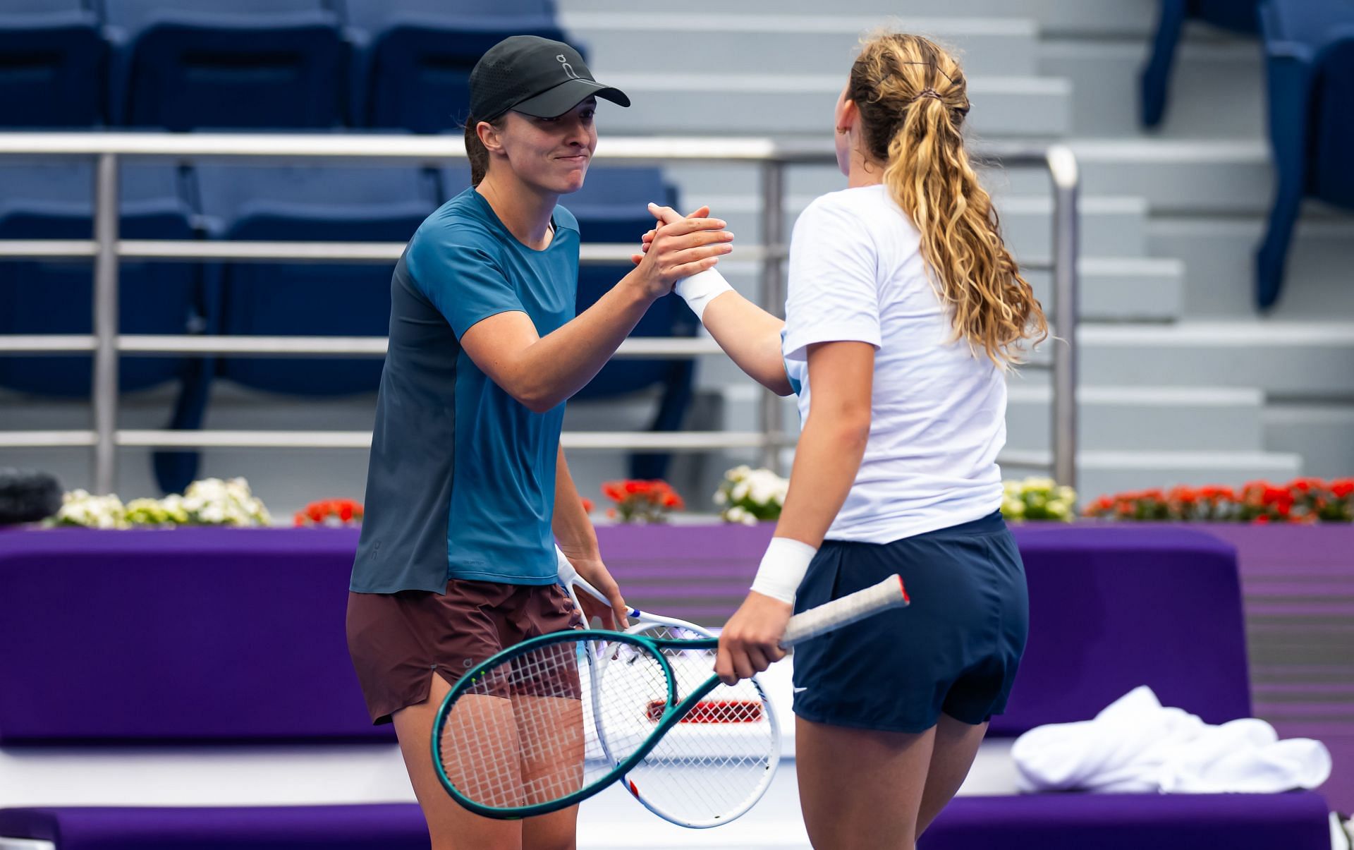 Iga Swiatek and Mirra Andreeva during a practice session - Source: Getty