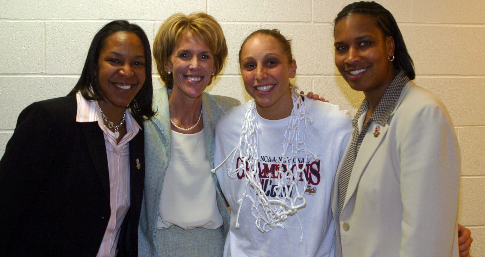 UConn women&#039;s basketball coaches Tonya Cardoza, Chris Dailey, and Jamelle Elliot celebrate with Diana Taurasi (second right) after winning their third straight national title. Photo: Getty