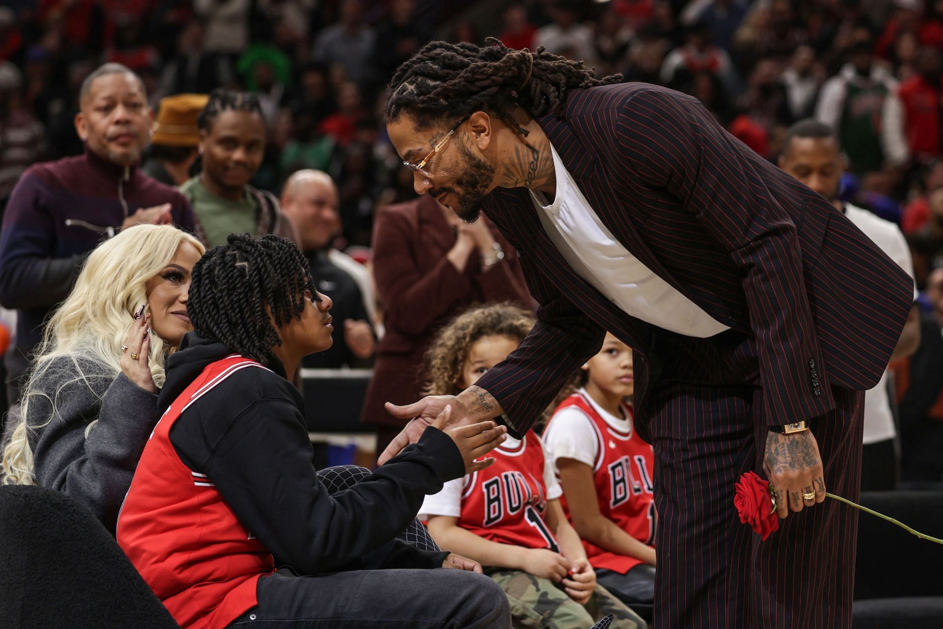 Rose and Derrick Rose Jr. at his jersey retirement at United Center - Source: Getty