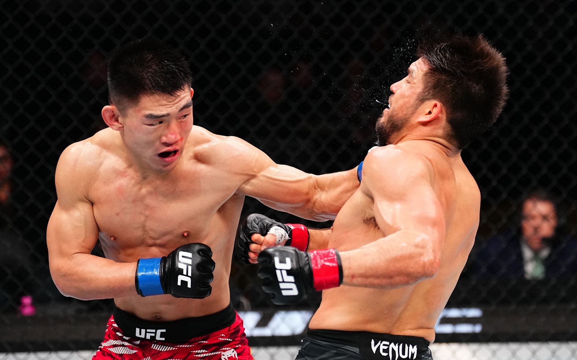 Song Yadong (left) landing a left hook on Henry Cejudo (right) in the UFC Seattle main event. [Image courtesy: Getty Images]