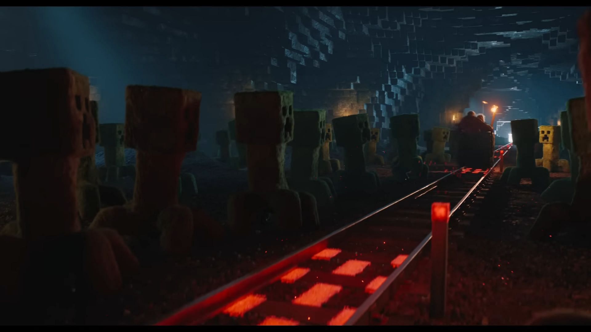 Powered rails run beneath the surface as creepers chase the protagonists (Image via YouTube/Mojang Studios)