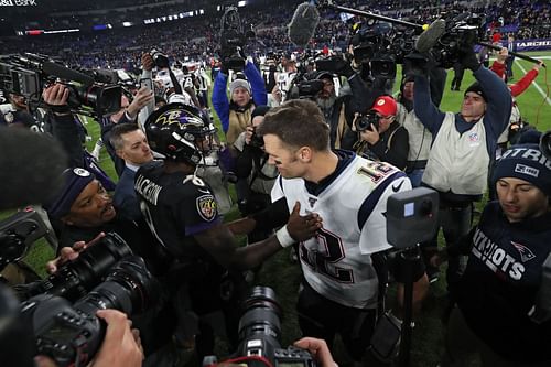  Quarterback Lamar Jackson #8 of the Baltimore Ravens and quarterback Tom Brady #12 of the New England Patriots talk after the Ravens defeated the Patriots at M&T Bank Stadium on November 3, 2019 in Baltimore, Maryland.  - Source: Getty