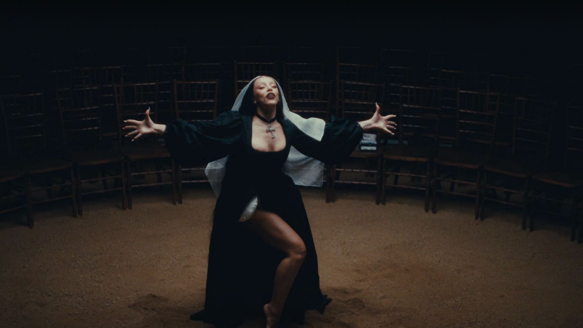 Doja Cat in a modified nun&#039;s attire with a cross hanging around her neck. (Image via YouTube/LLOUD)