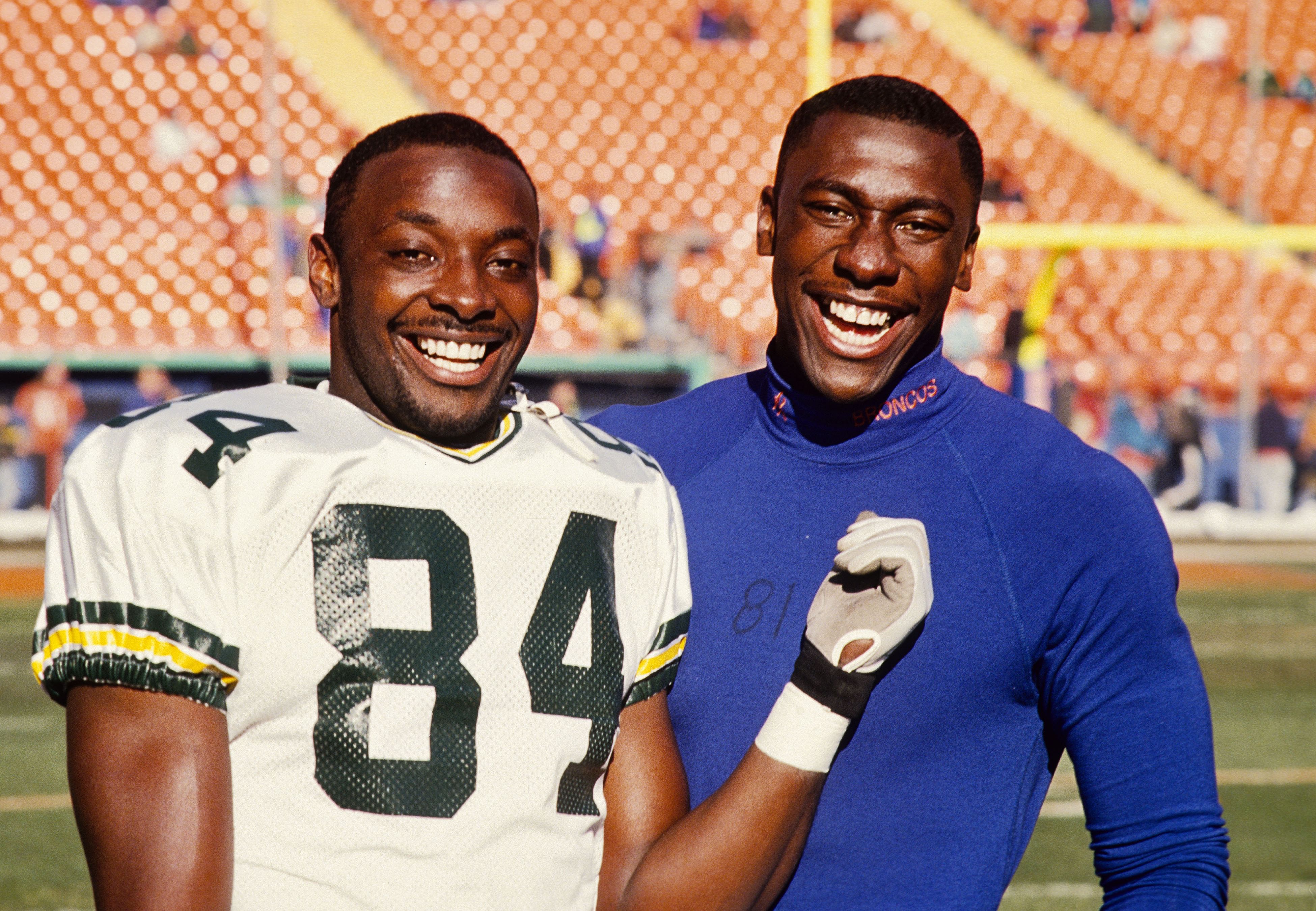 Green Bay Packers receiver Sterling Sharpe (left) poses with his younger brother Denver Broncos receiver Shannon Sharpe (right). (Credits: IMAGN)